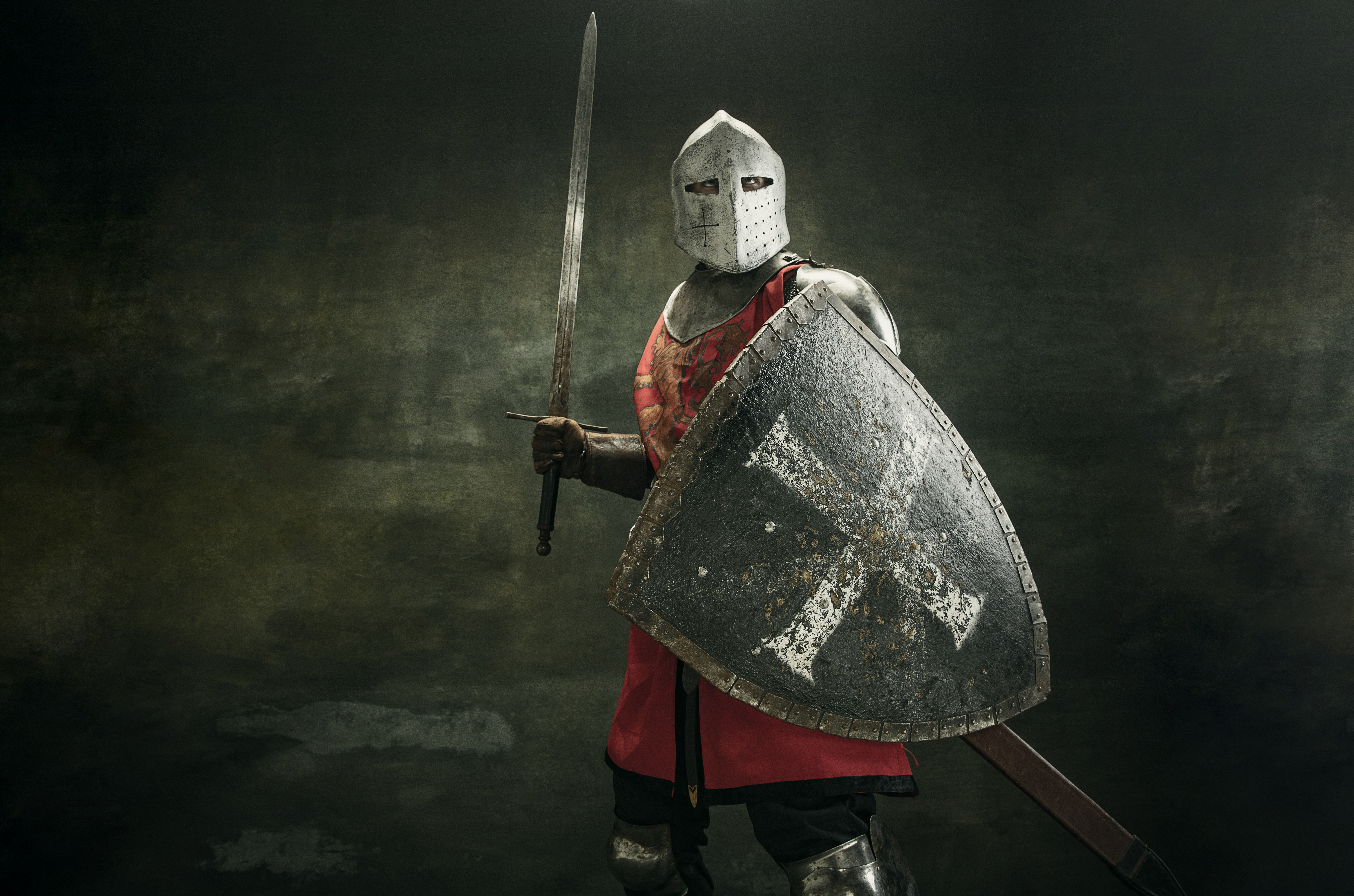 One medeival warrior or knight in armor and helmet with shield and sword