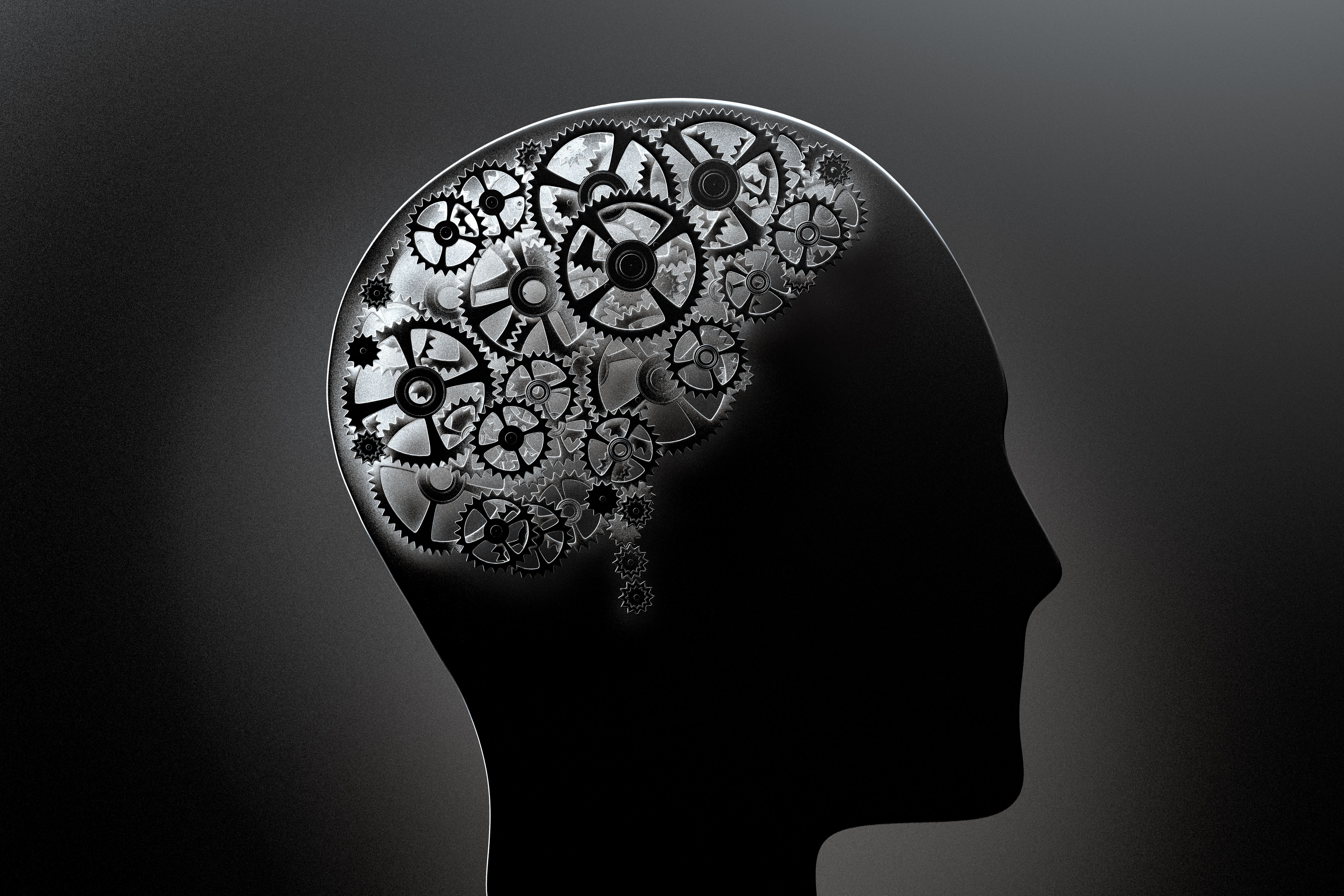a conceptual image of a human brain made of cogwheels