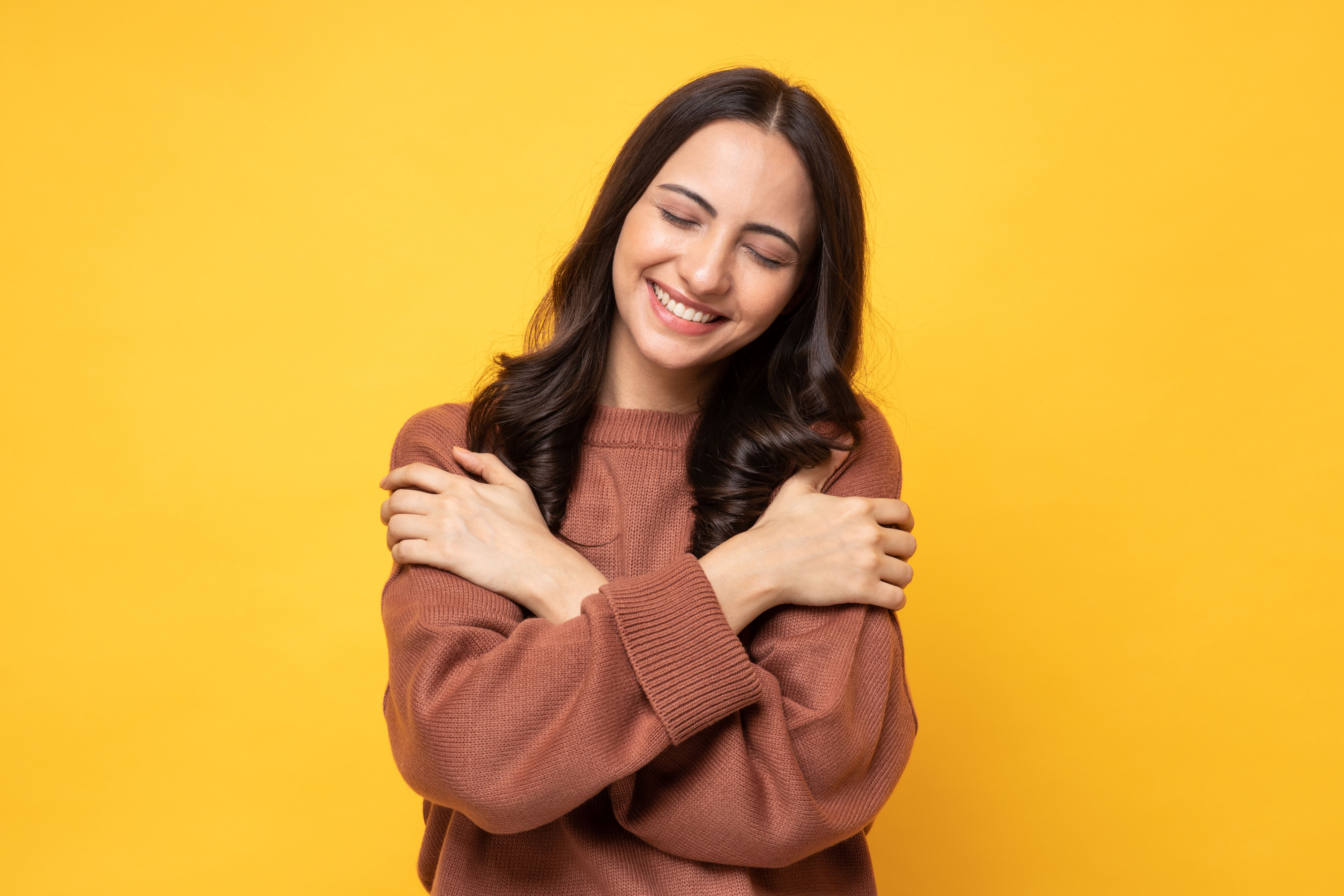 woman hugging after finding self love 