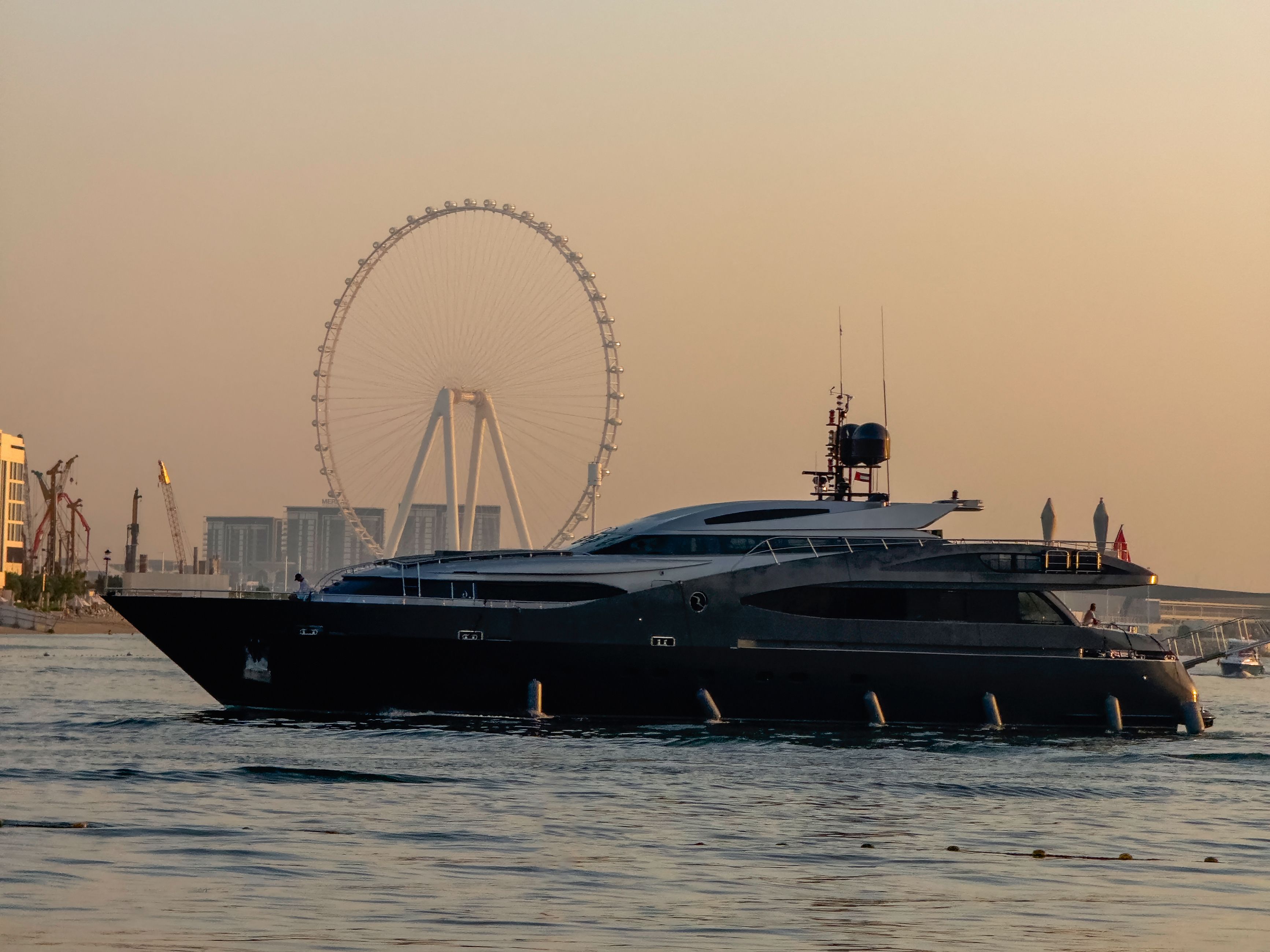 The black huge mega yacht is moored in sea. Dubai