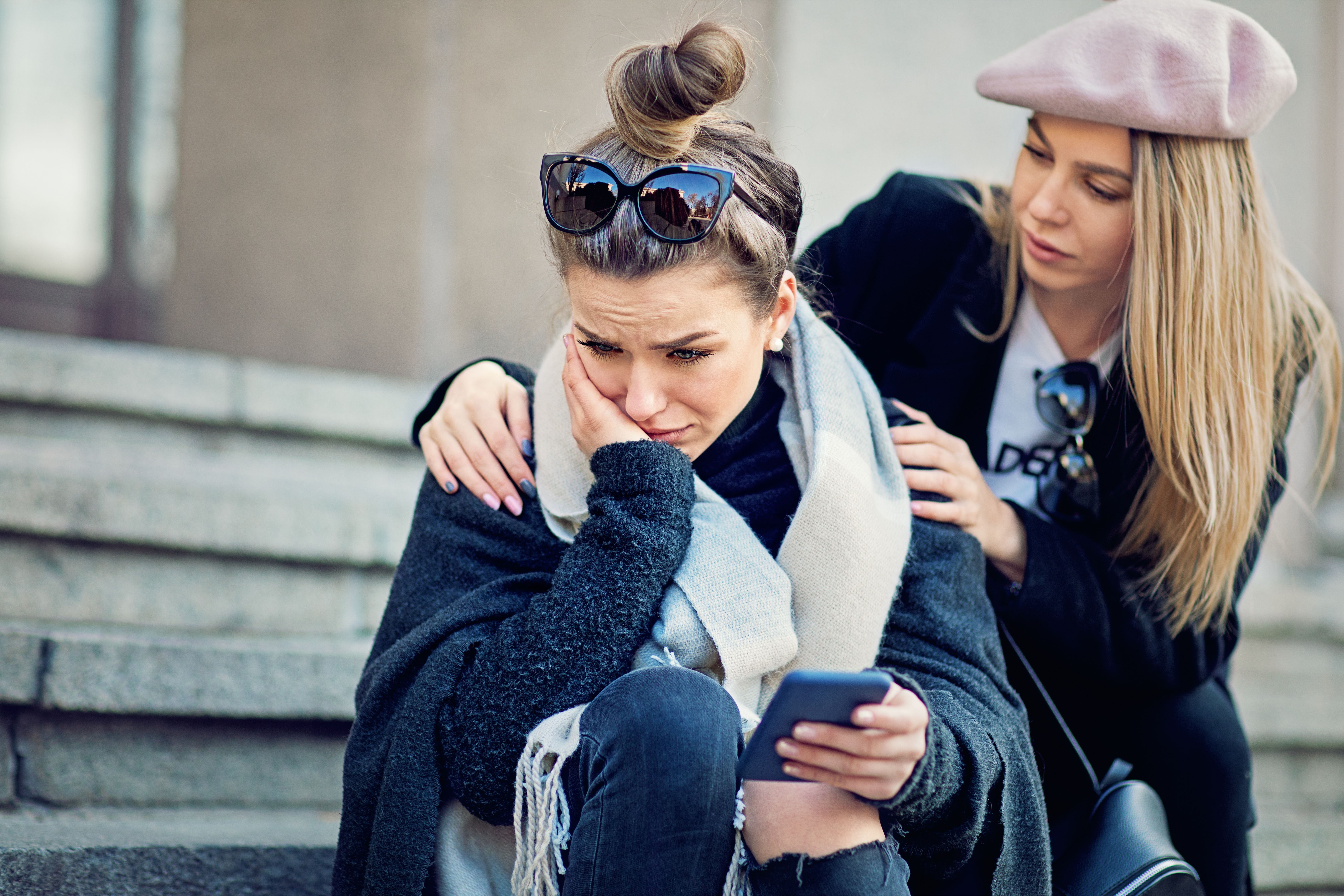 Girl is consoling her girlfriend after break up