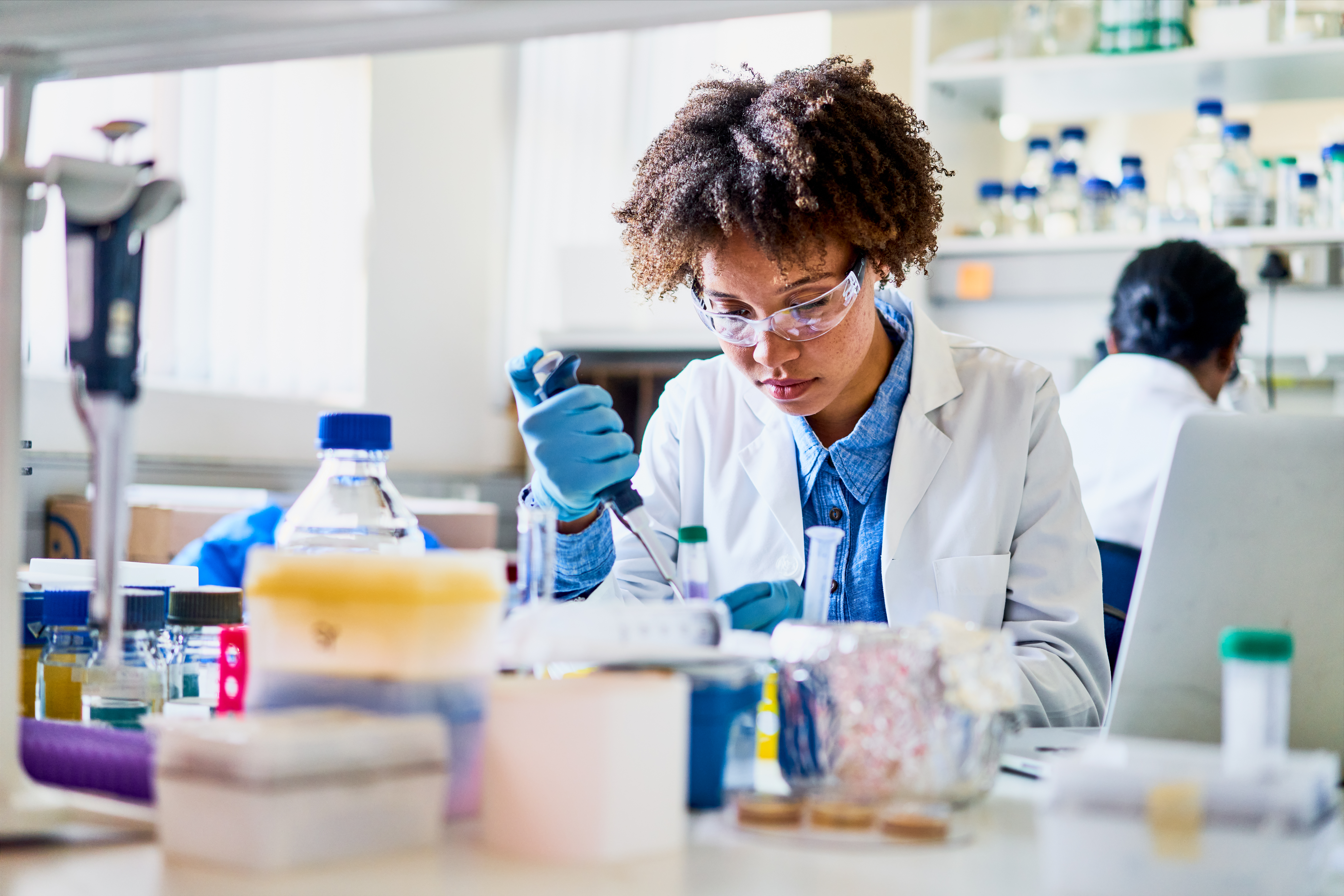 Young scientist using a pipette to analyzing a sample in a lab Young scientist using a pipette to analyzing a sample in a lab