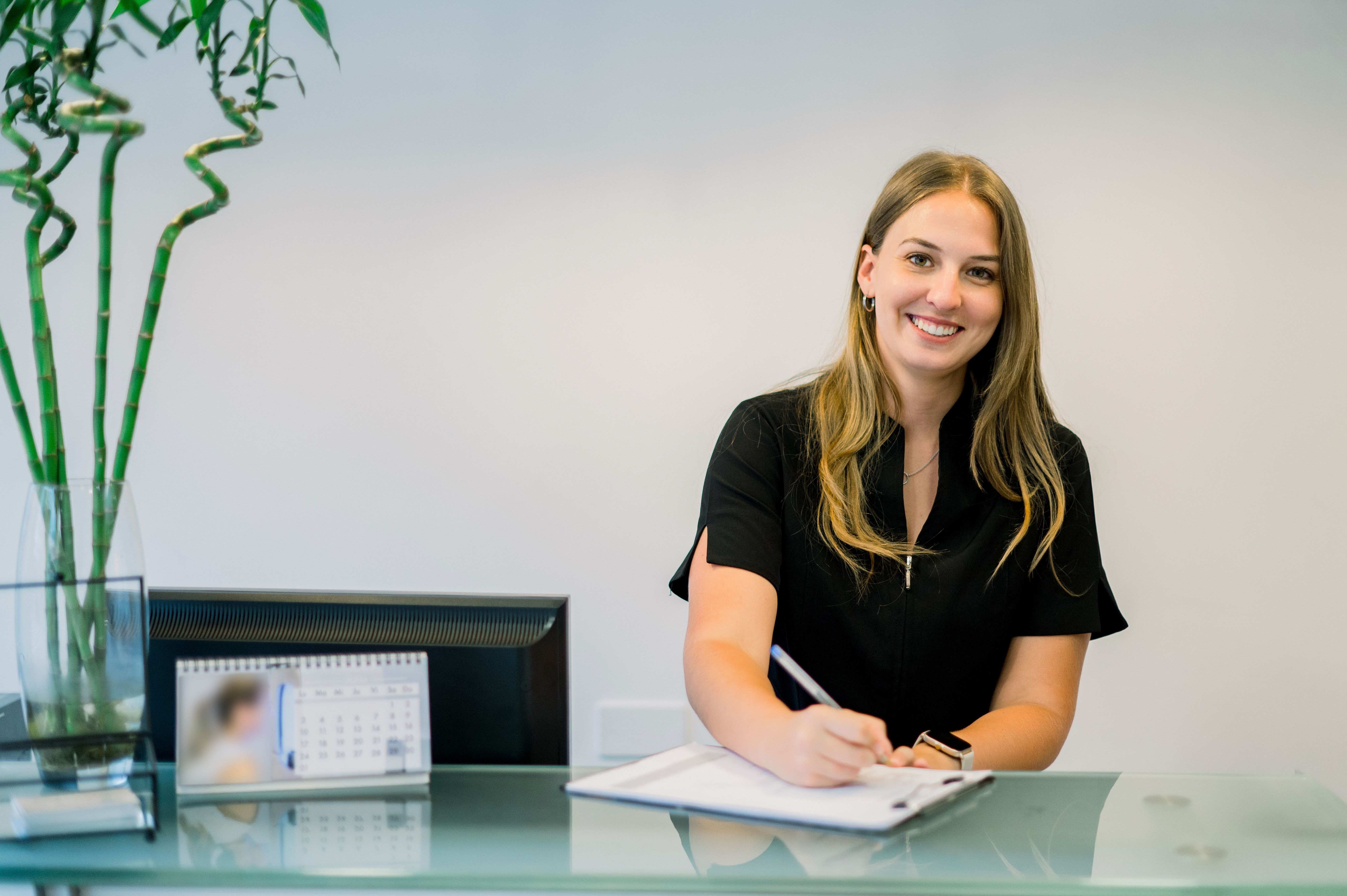 Friendly receptionist at esthetic clinic desk