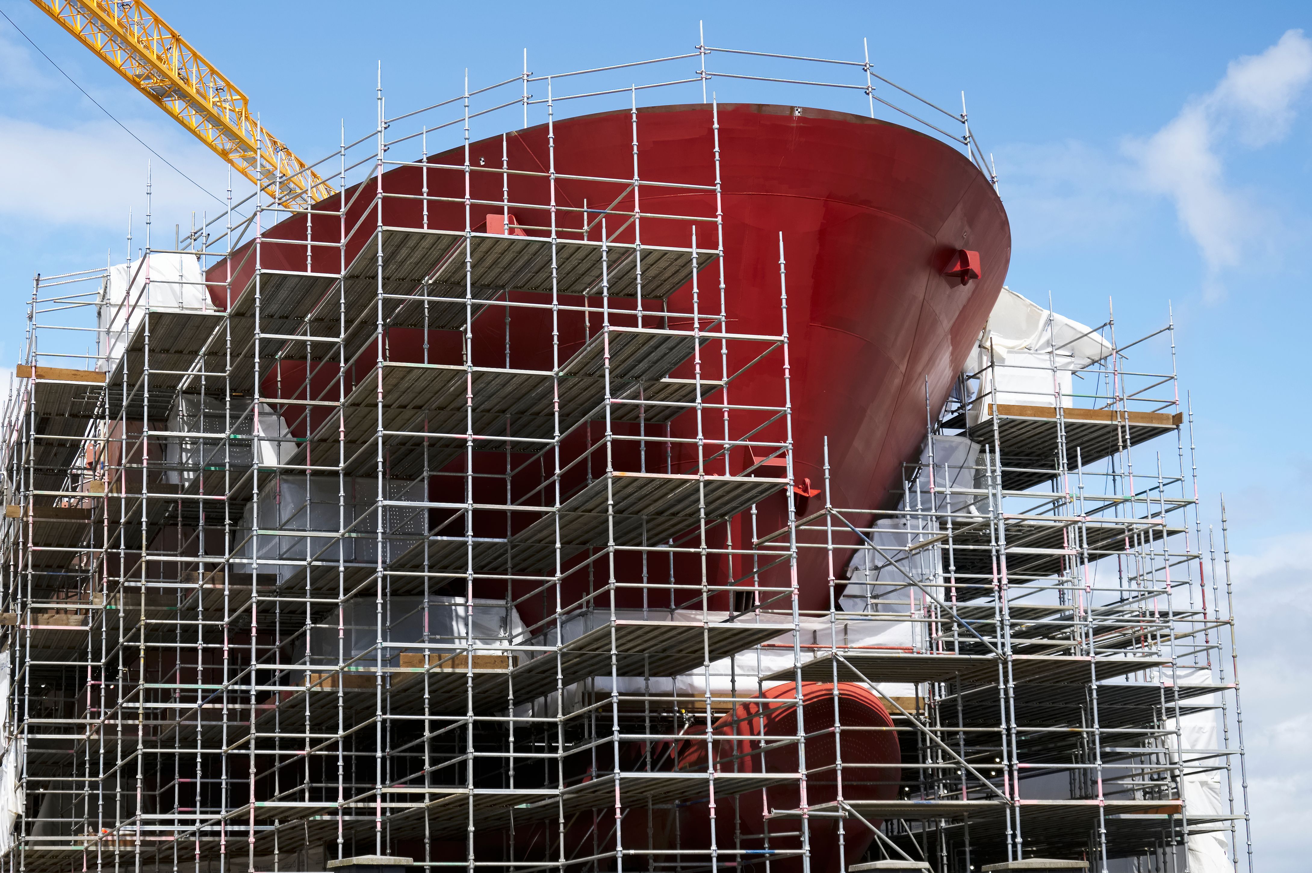 Shipbuilding and crane during ferry construction surrounded by scaffold
