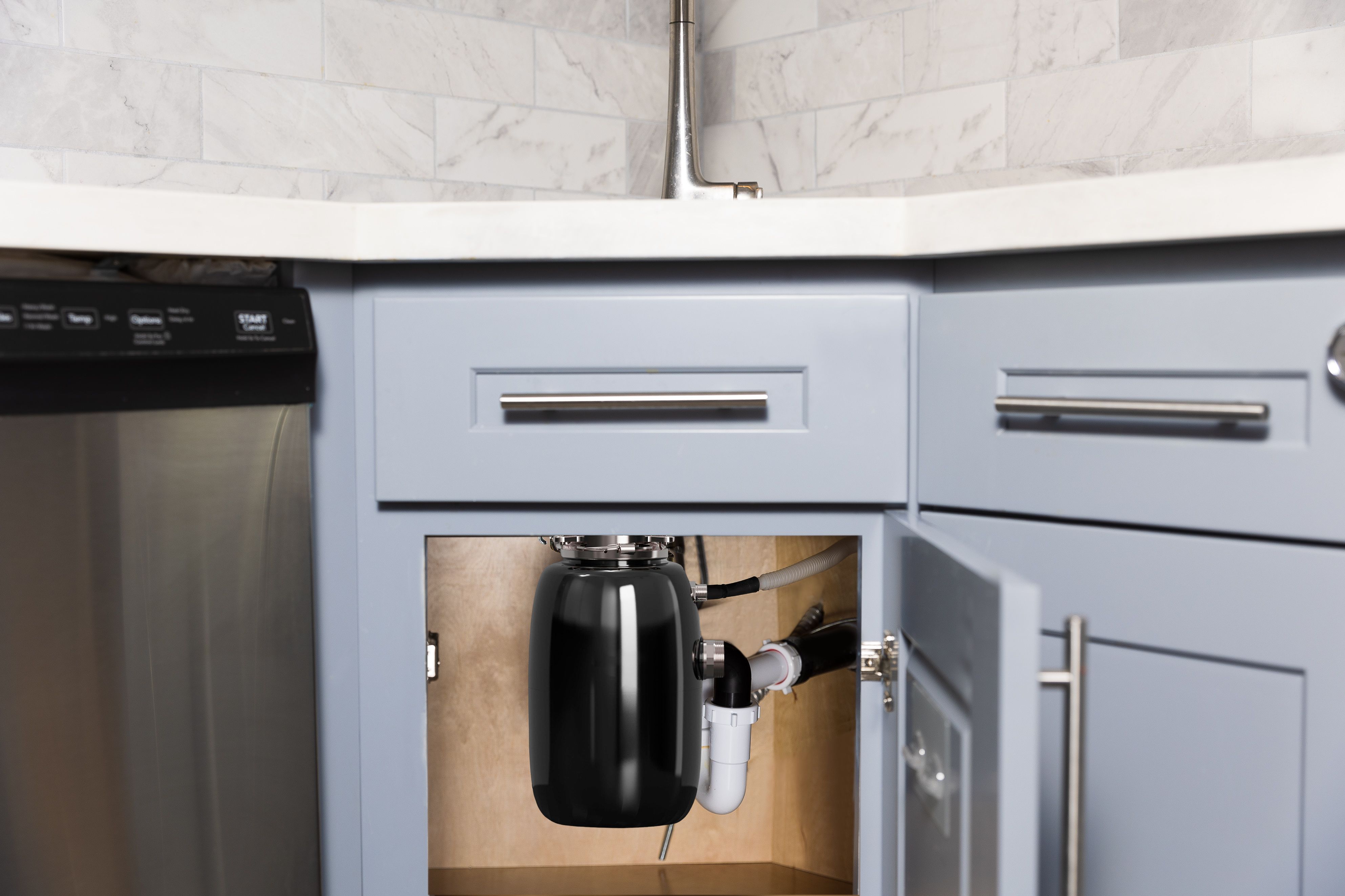 Garbage disposer installed under the sink in the kitchen