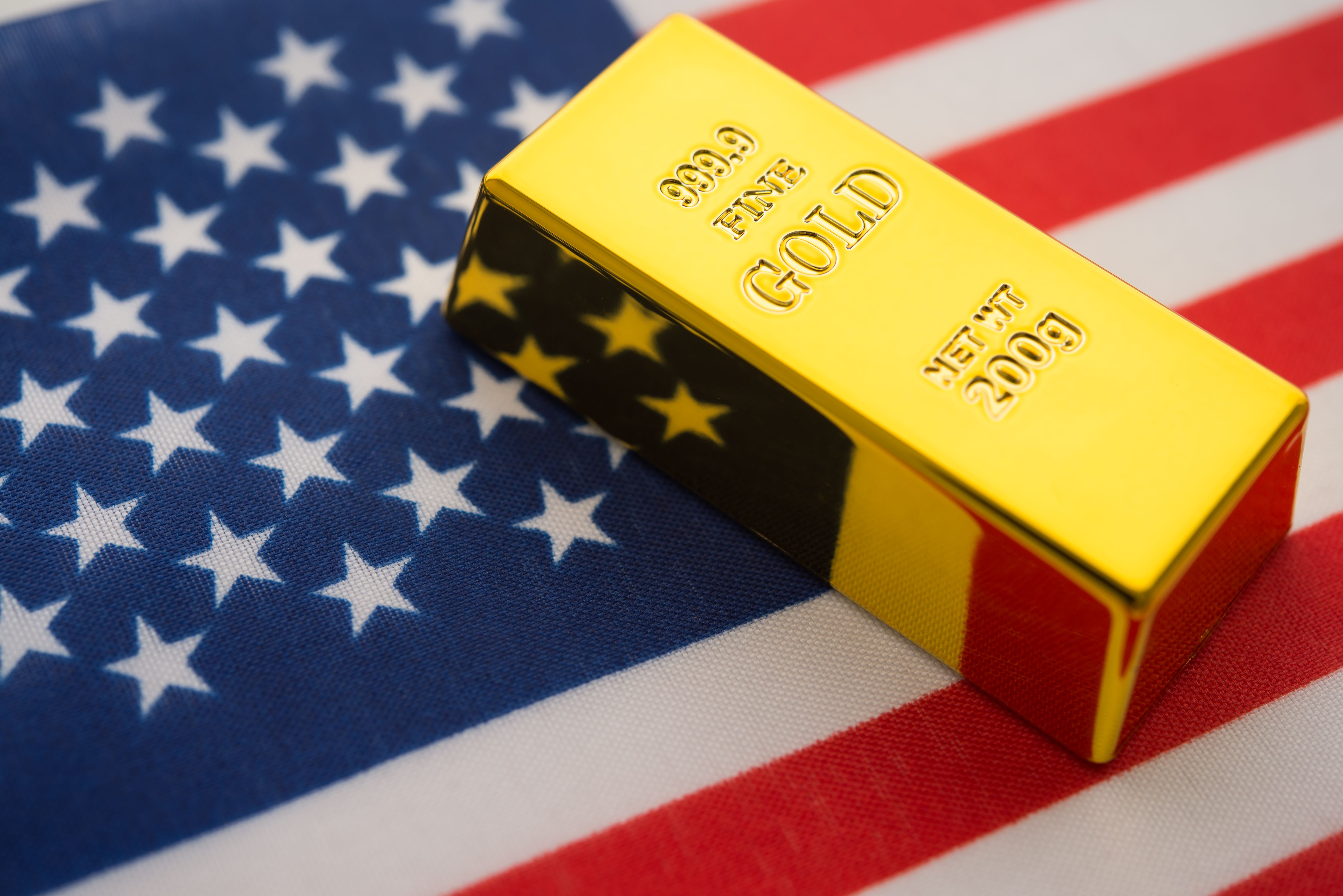 Gold bar with American flag background.