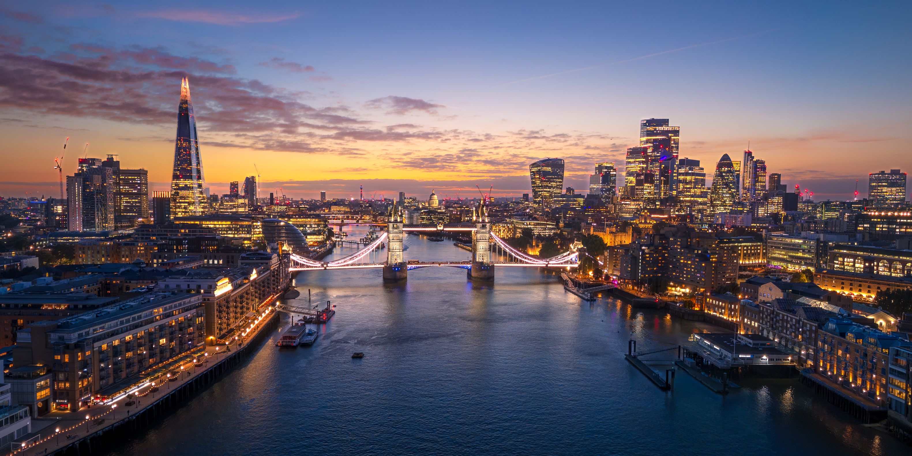 London City Skyline with Tower Bridge Illuminated at Sunset Aerial Panorama, England, United Kingdom