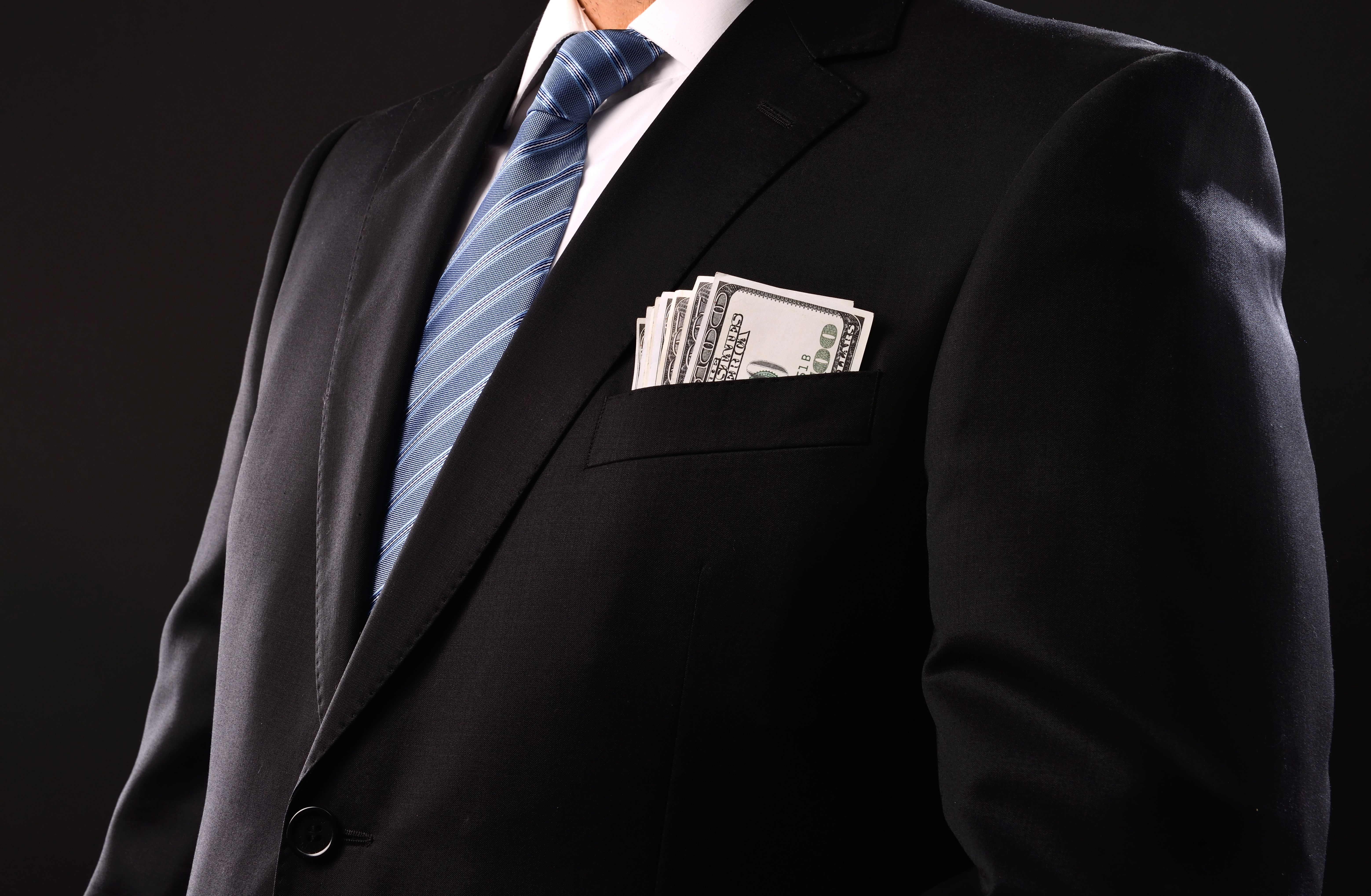 Money in businessman's pocket