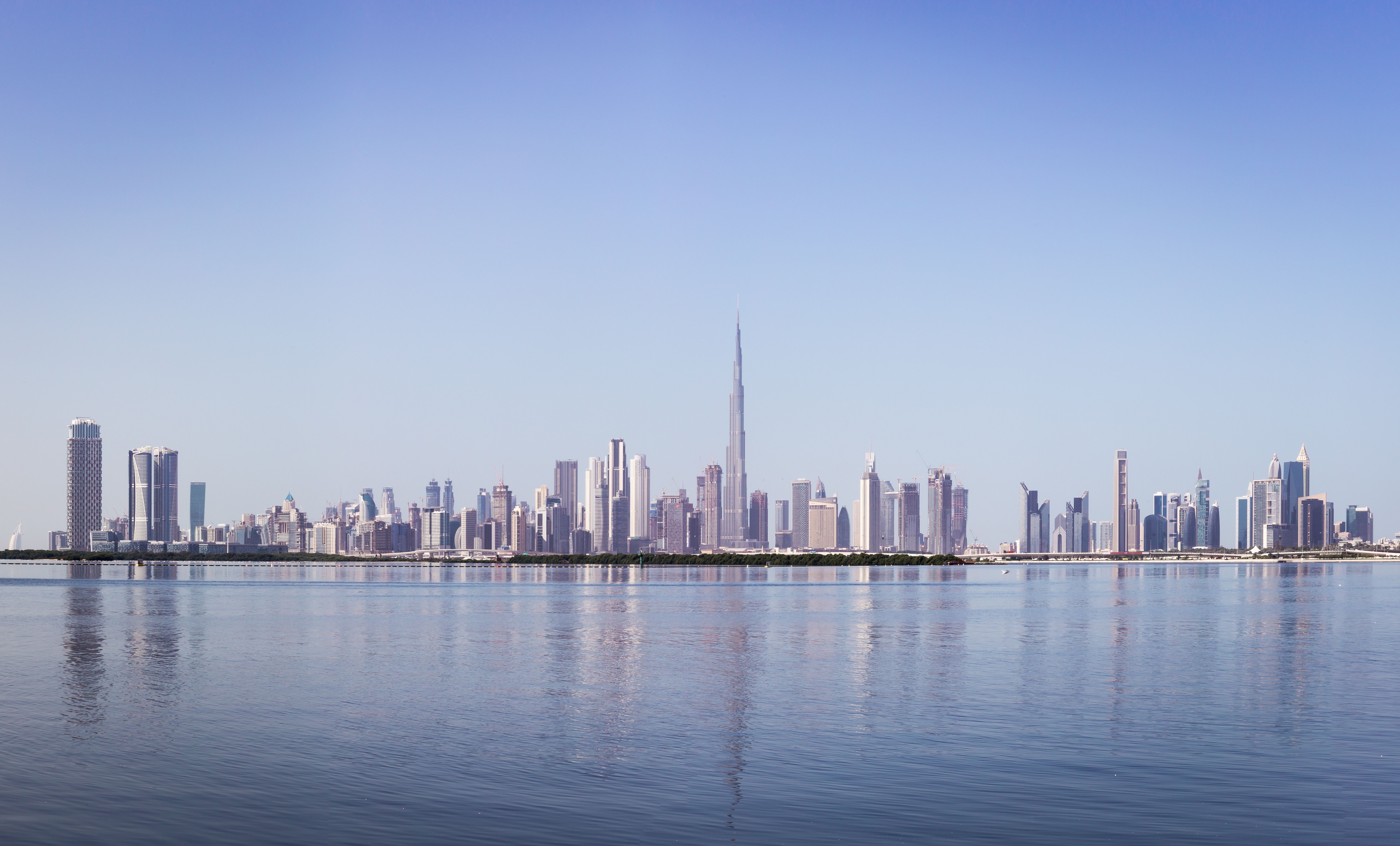 Dubai Downtown skyline panorama with reflections in Dubai Creek, cold colors, United Arab Emirates Dubai Downtown skyline panorama with reflections in Dubai Creek, cold colors, United Arab Emirates