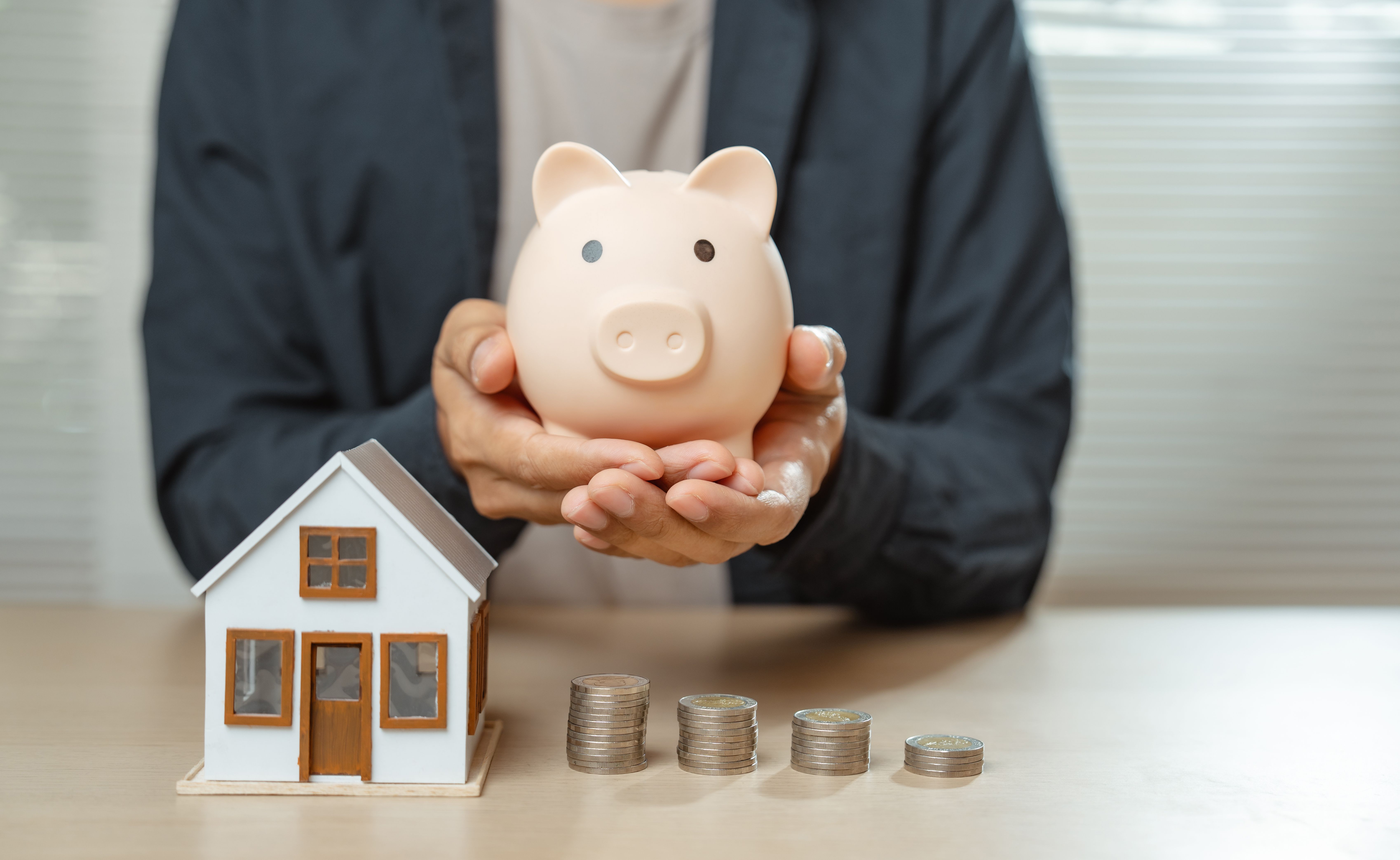 Investing in property or real estate financial concept. Man calculate planning strategy and income profit with house model for make money or create wealth. Investing in property or real estate financial concept. Man calculate planning strategy and income profit with house model for make money or create wealth.