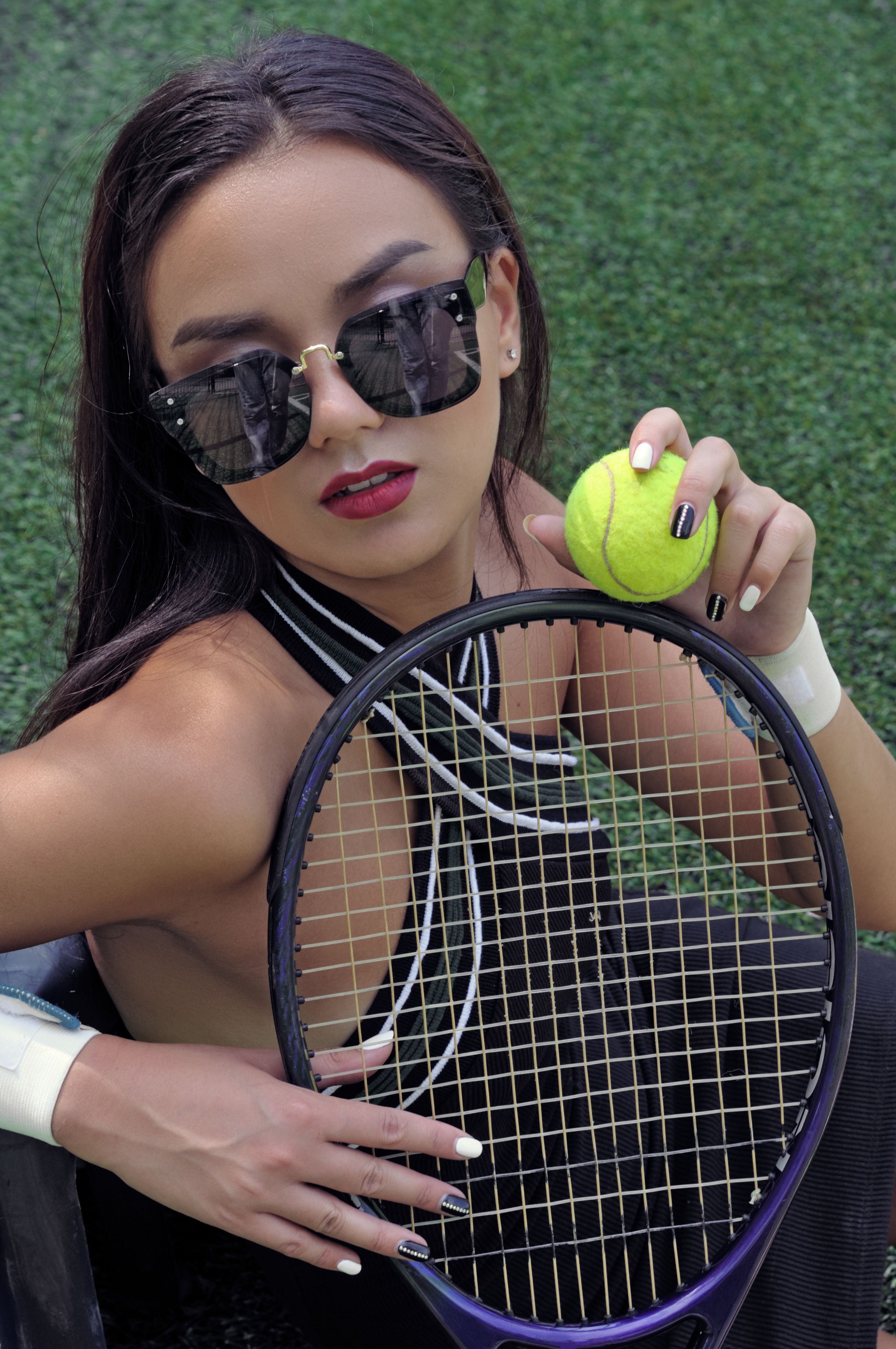 Portrait of a girl with a tennis racket and ball.