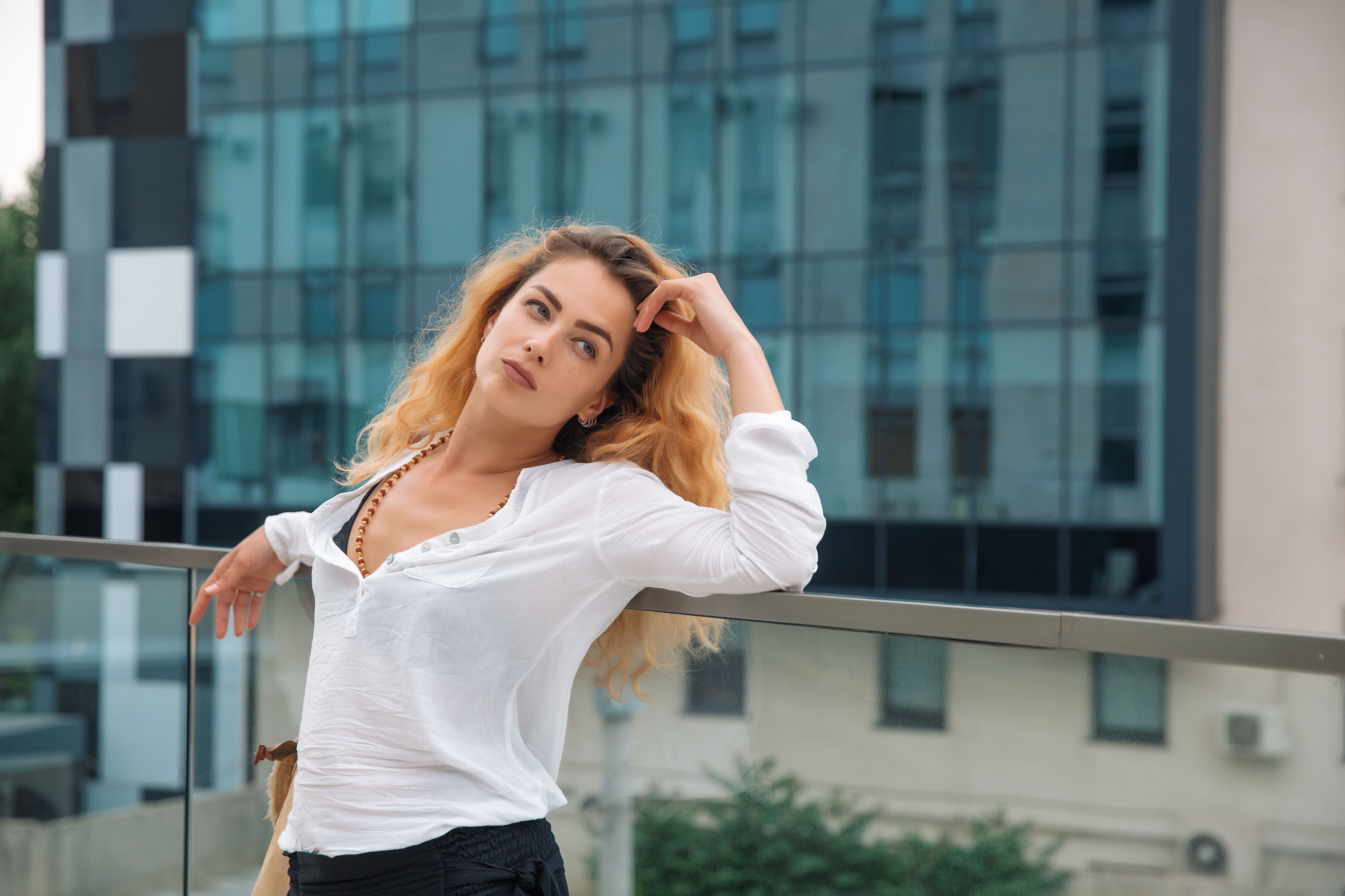 Woman with curly hair leaned on the railing and thought Woman with curly hair leaned on the railing and thought