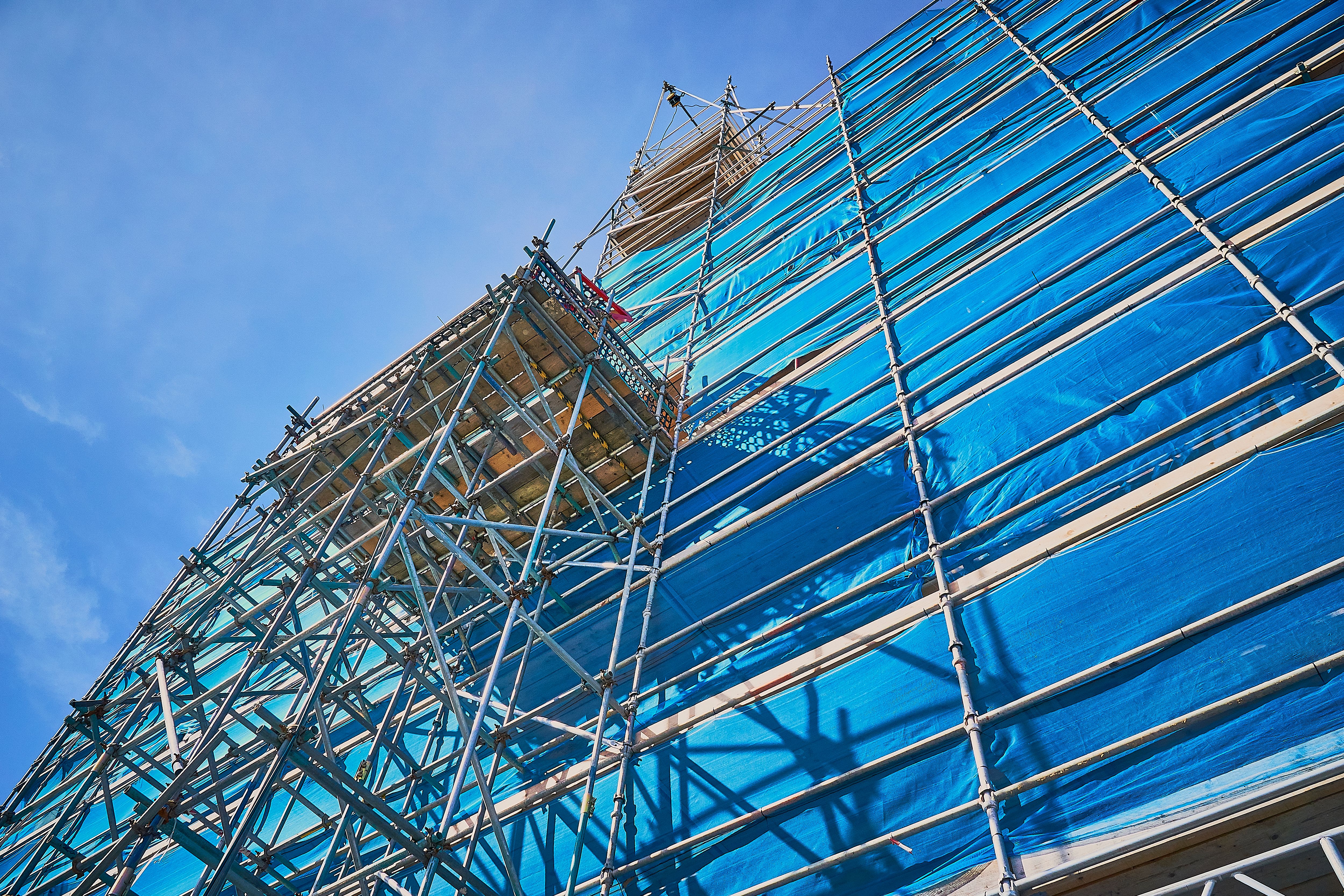Blue scaffolding with a dark blue sky on sunny day Blue scaffolding with a dark blue sky on sunny day