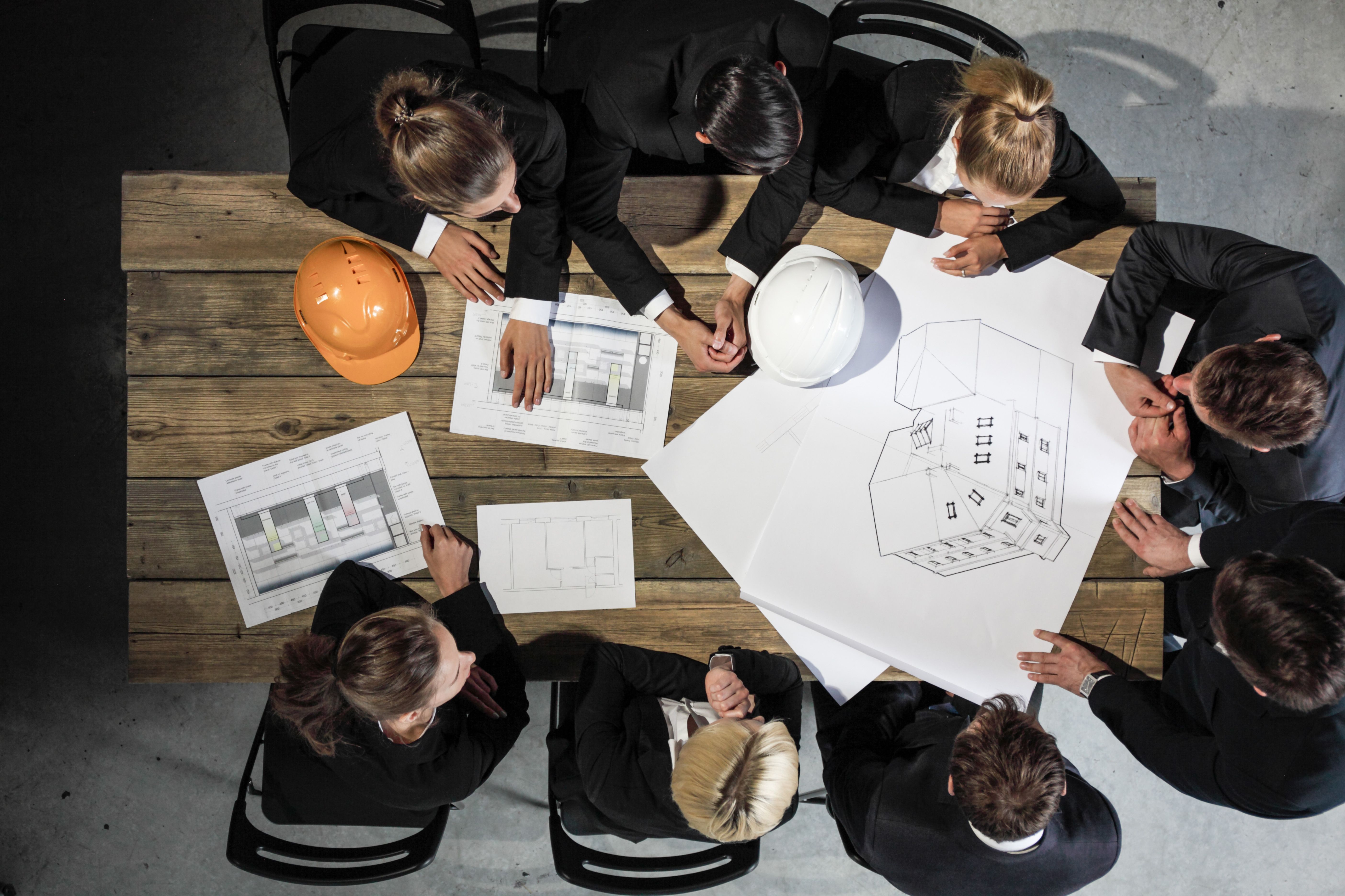 Business people with construction blueprint