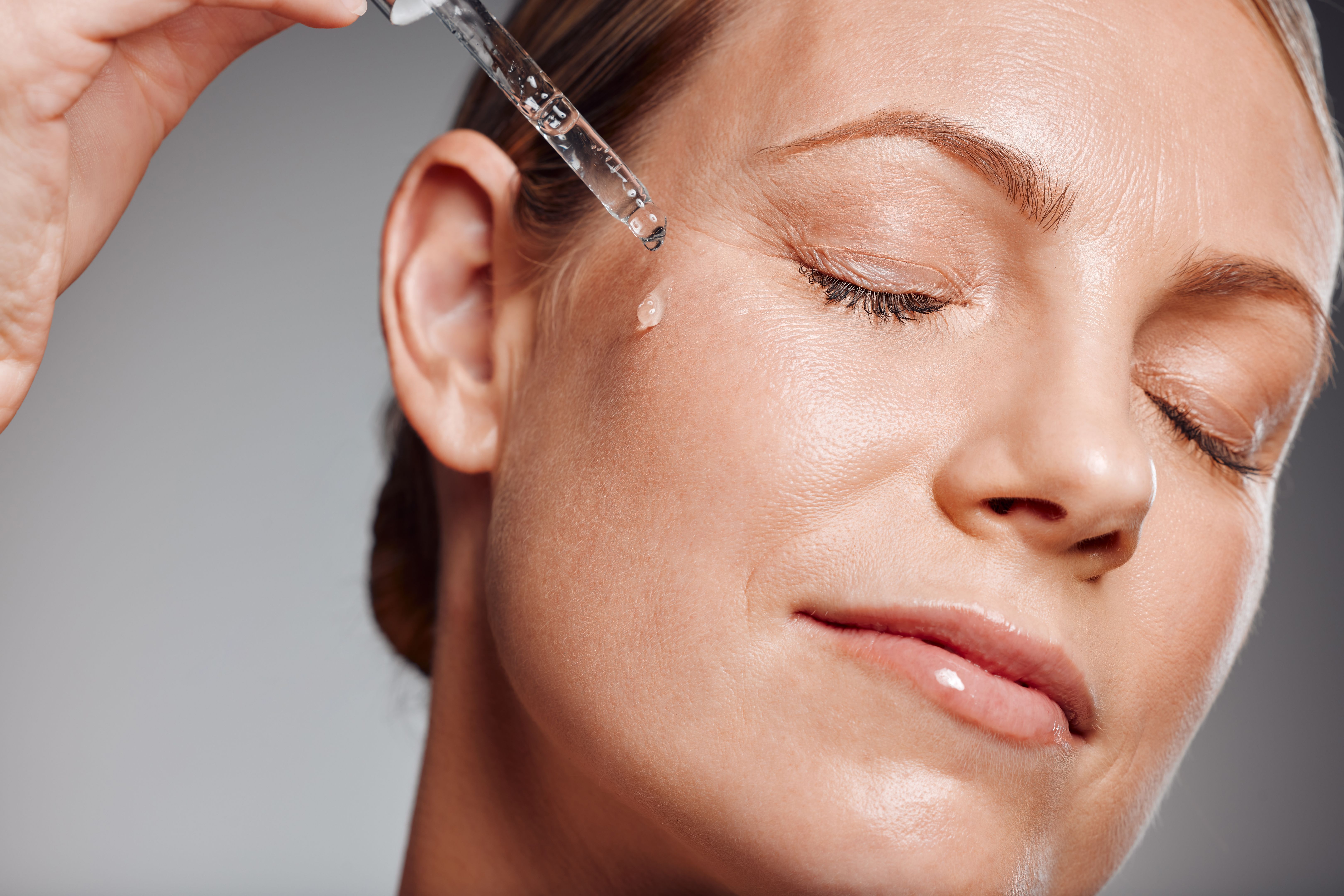 women applying serum