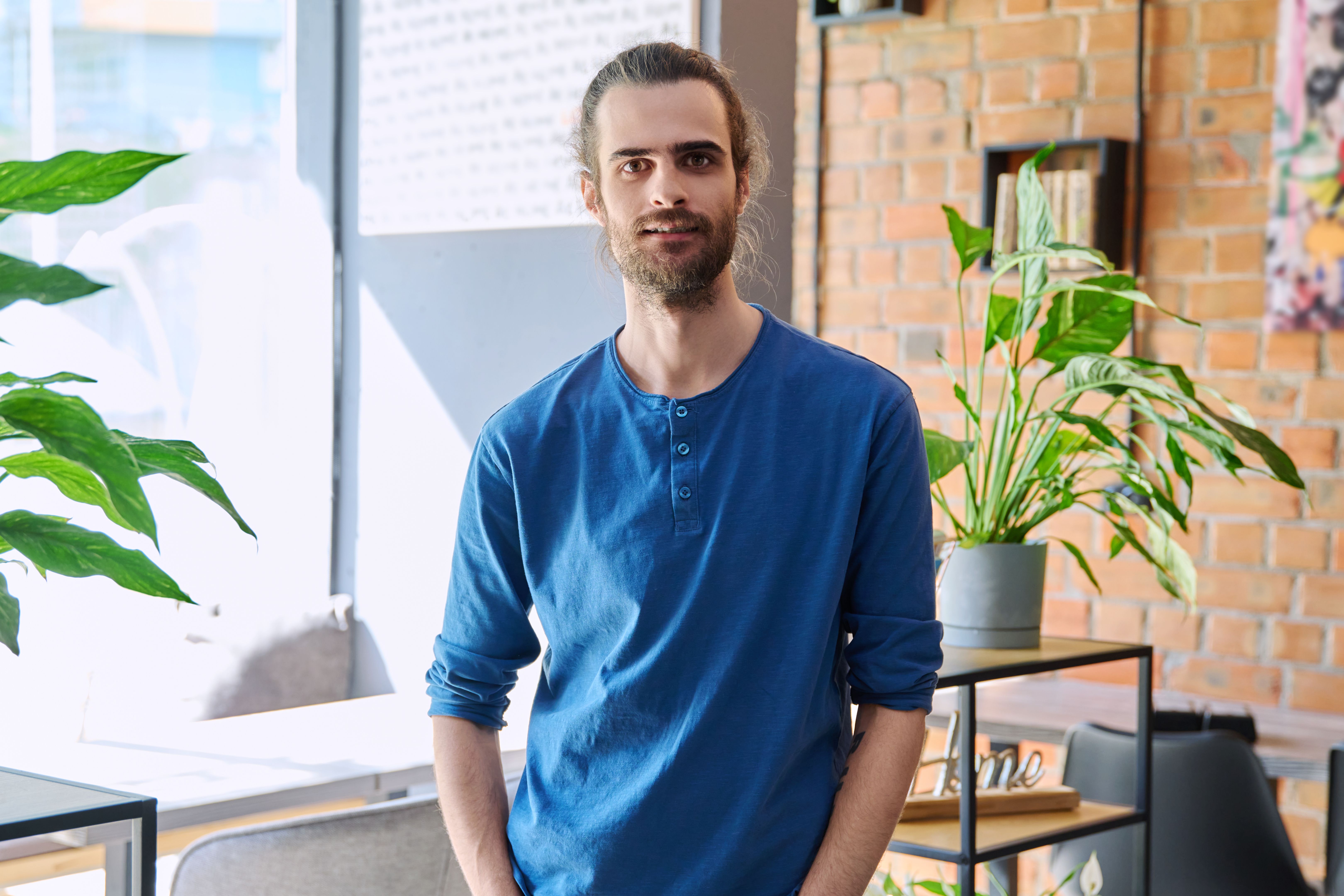Portrait of young confident handsome man looking at camera