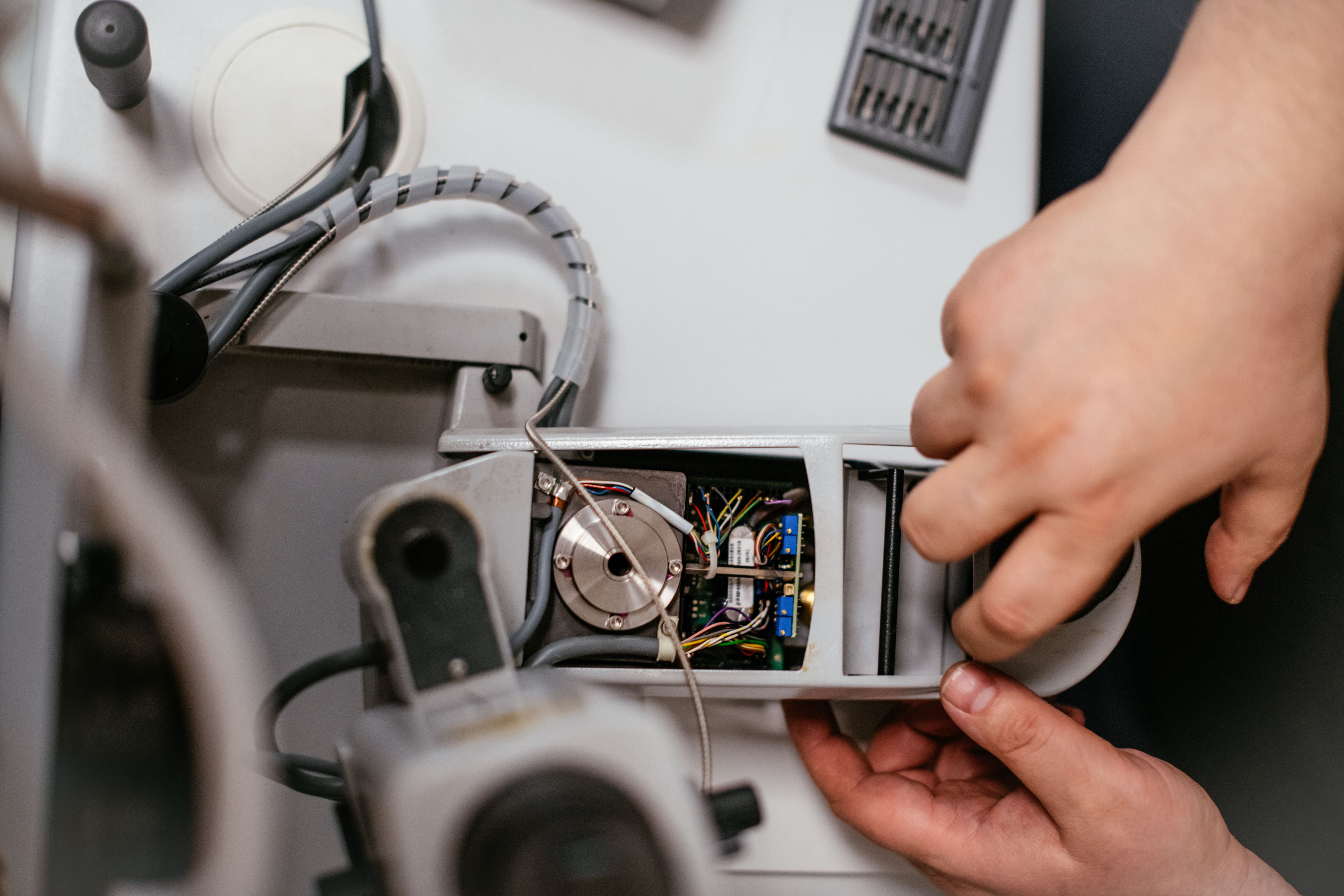 technician repairing sewing machine