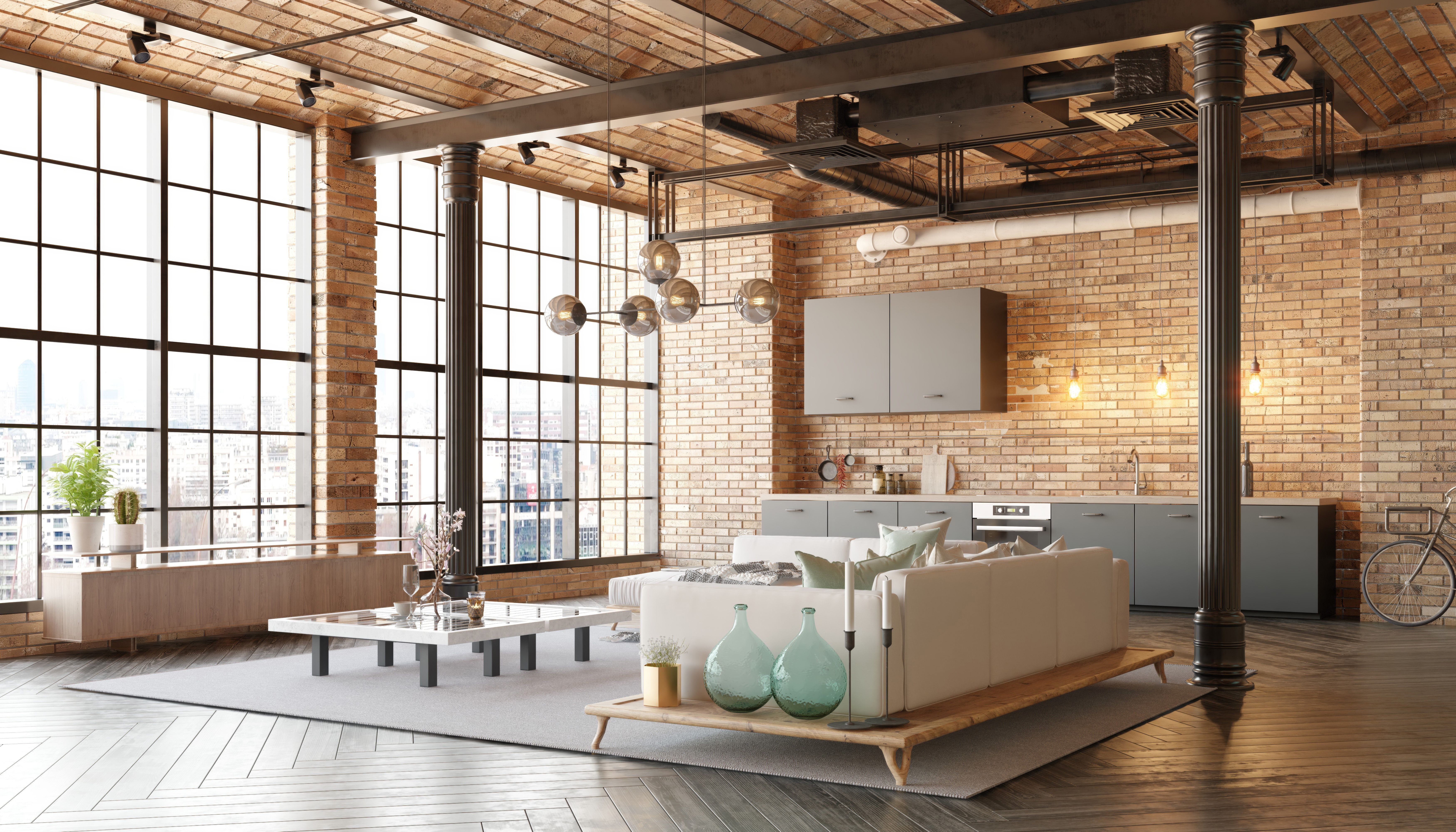 A modern loft living room with a couch, a kitchen