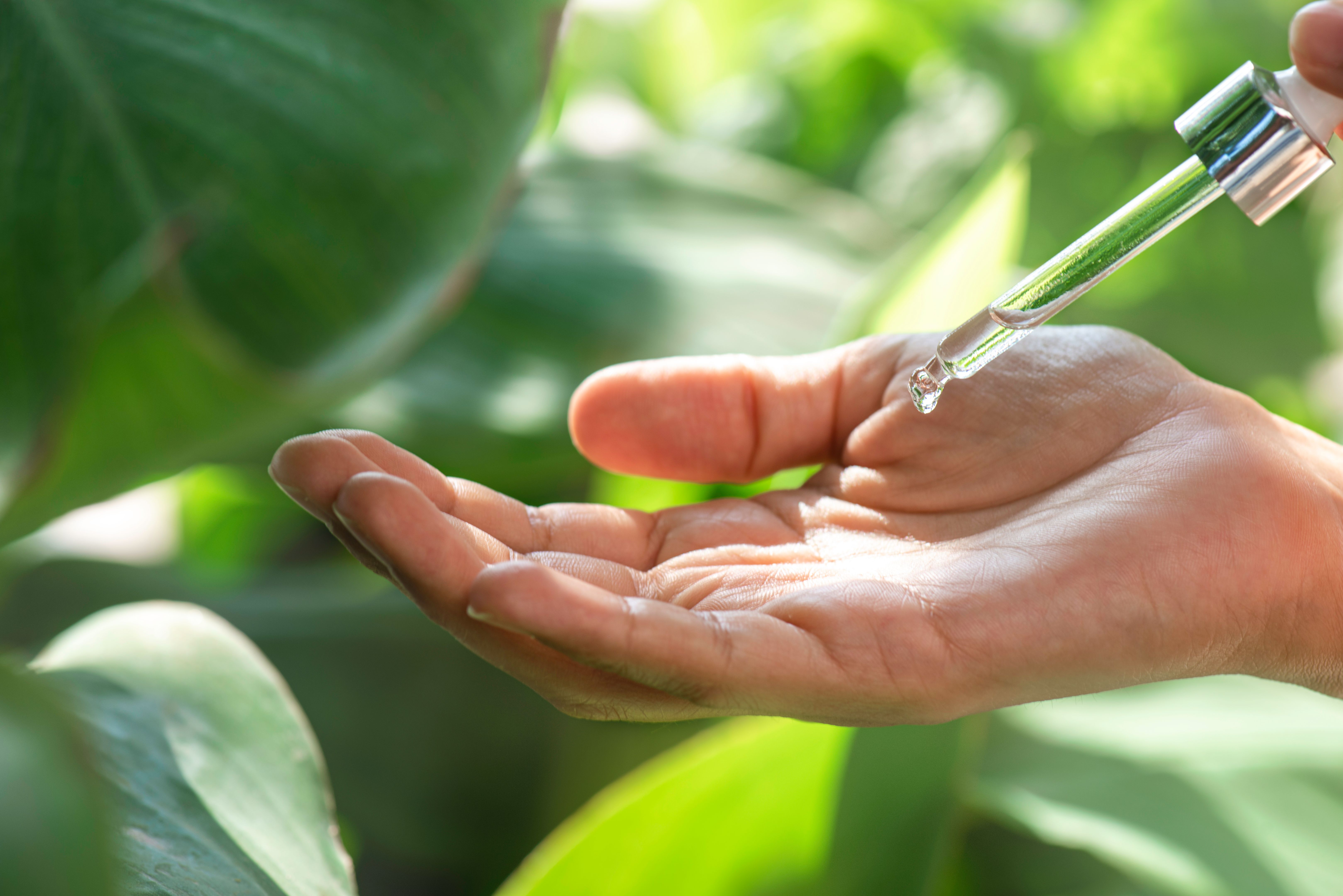 Woman Dripping Serum With Dropper