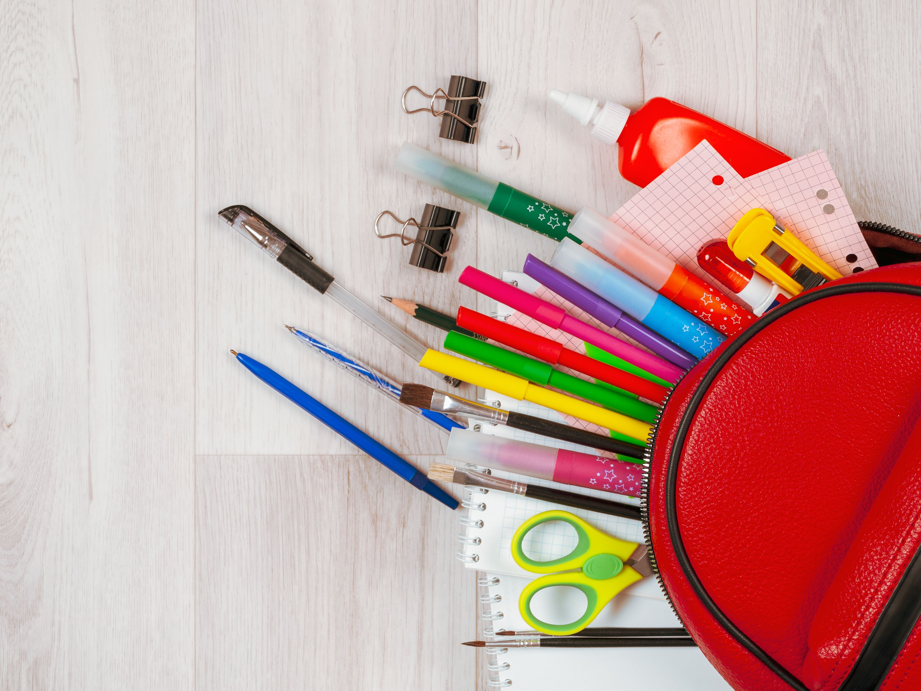 Stationery for studying against the background of a student's backpack