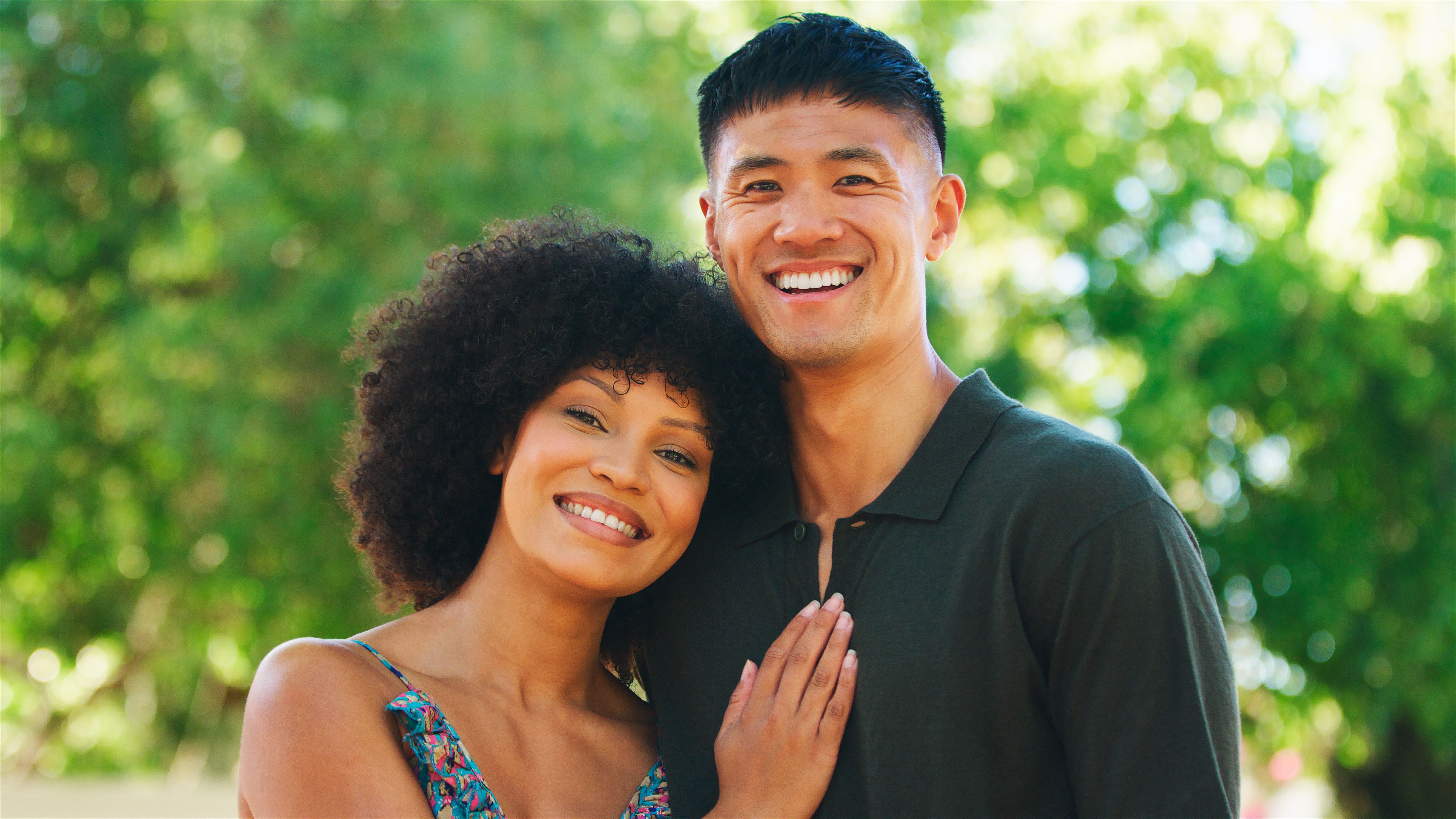 Couple Smiling Together Outdoors During a Sunny Day in a Park