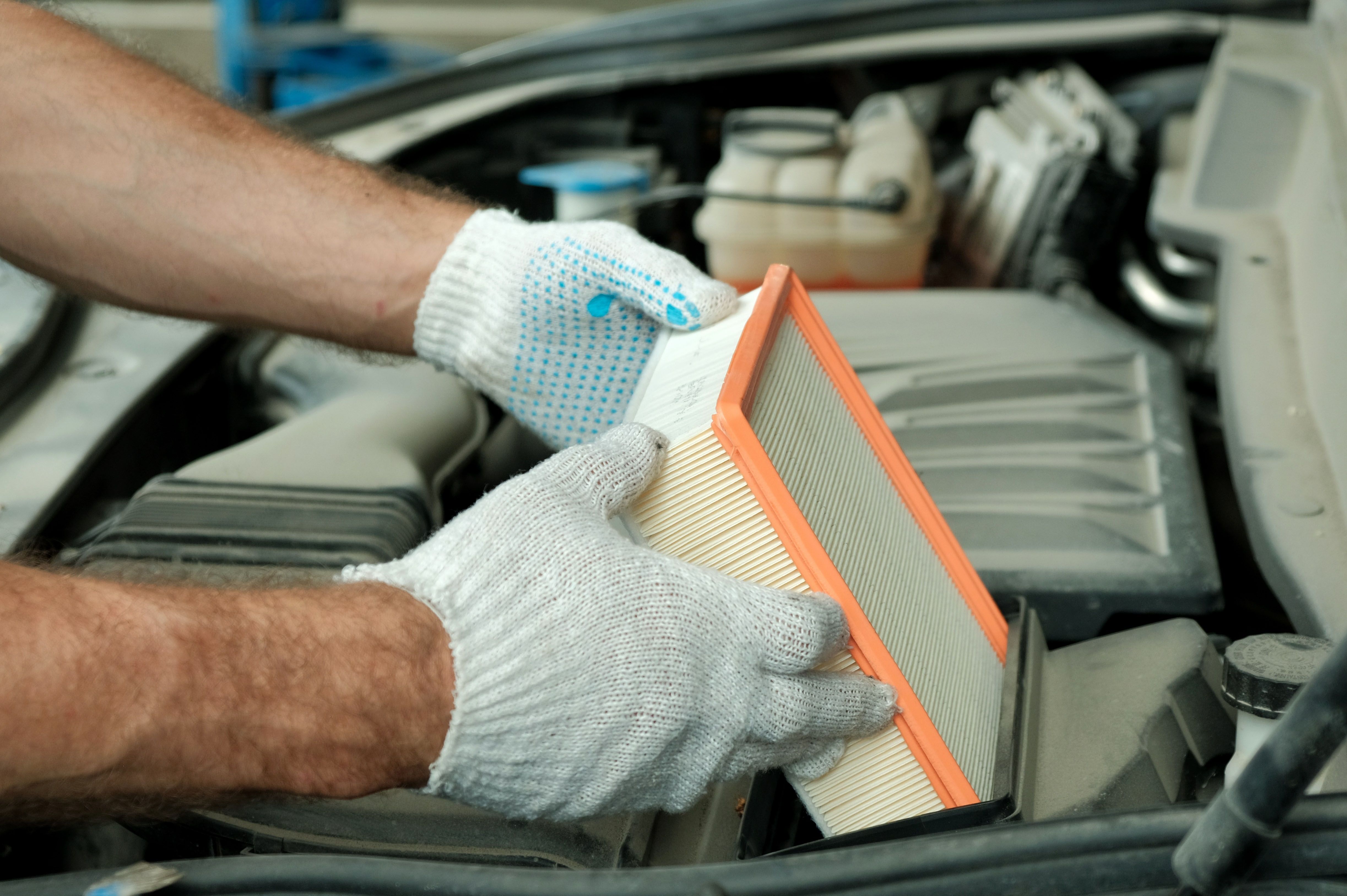mechanic replacing air filter
