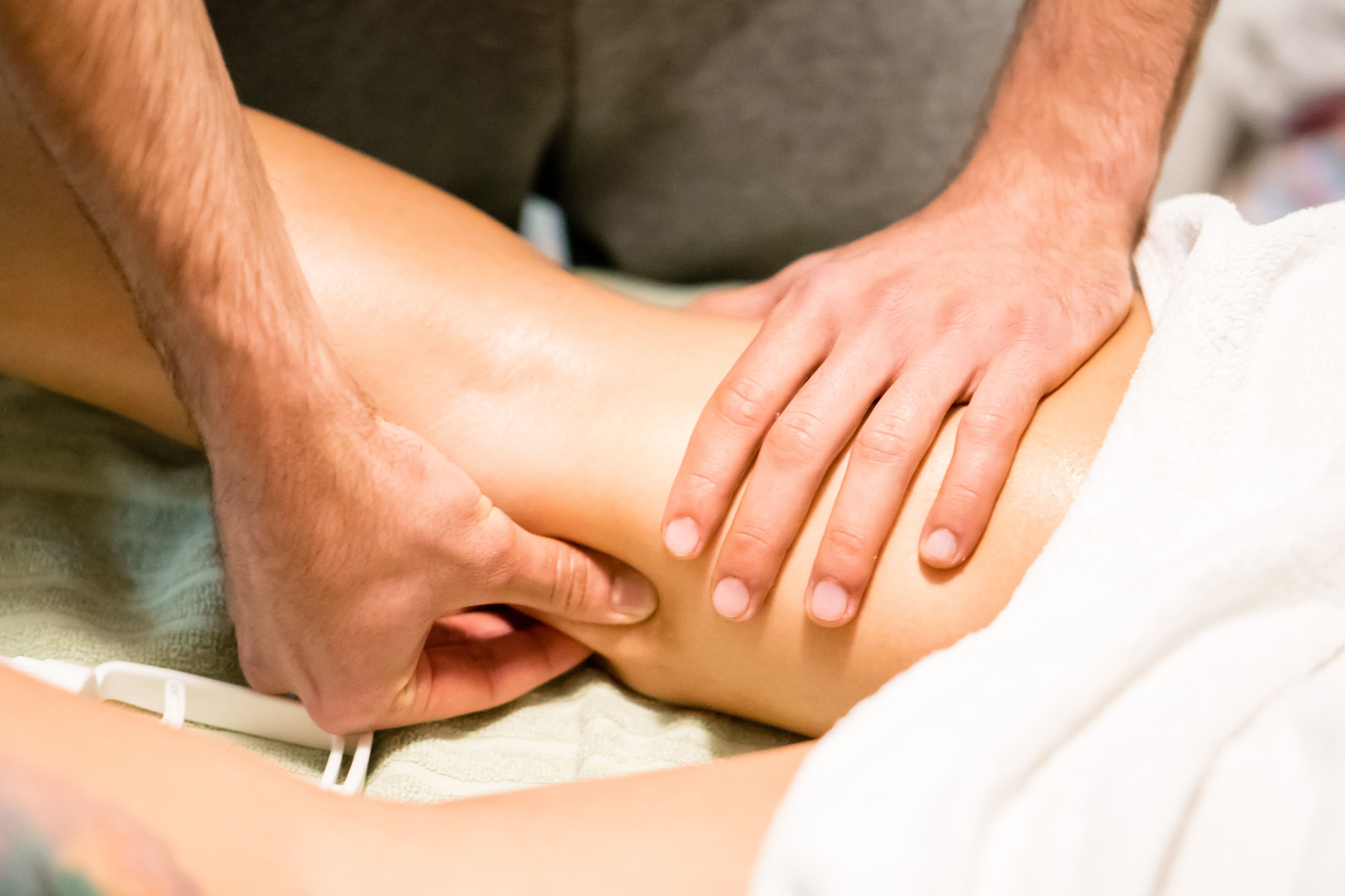 Man hands giving a leg massage, alternative therapy
