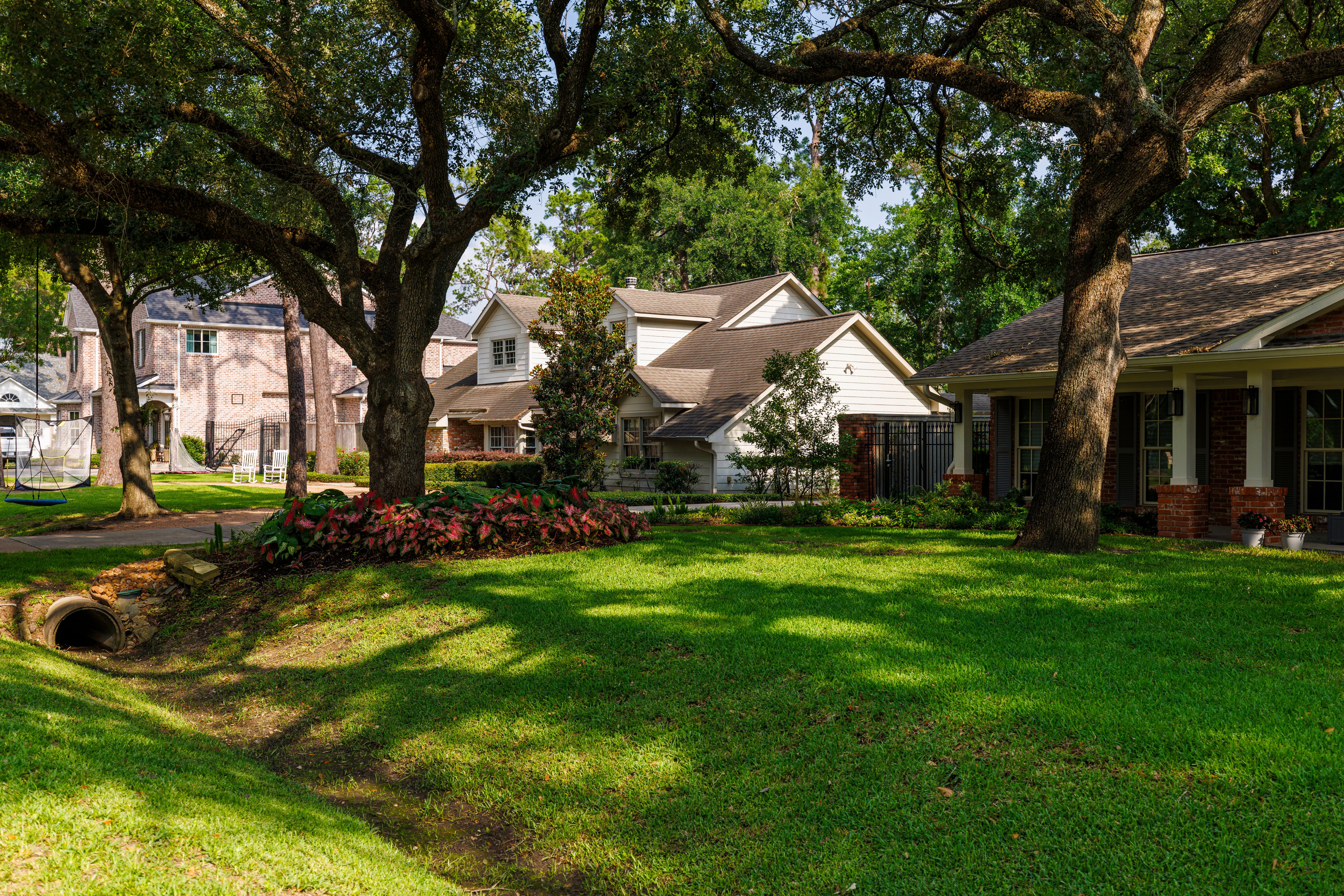 Strolling through shaded wealthy neighborhood. Residential neighborhood adorn tree-lined street in East Houston, TX