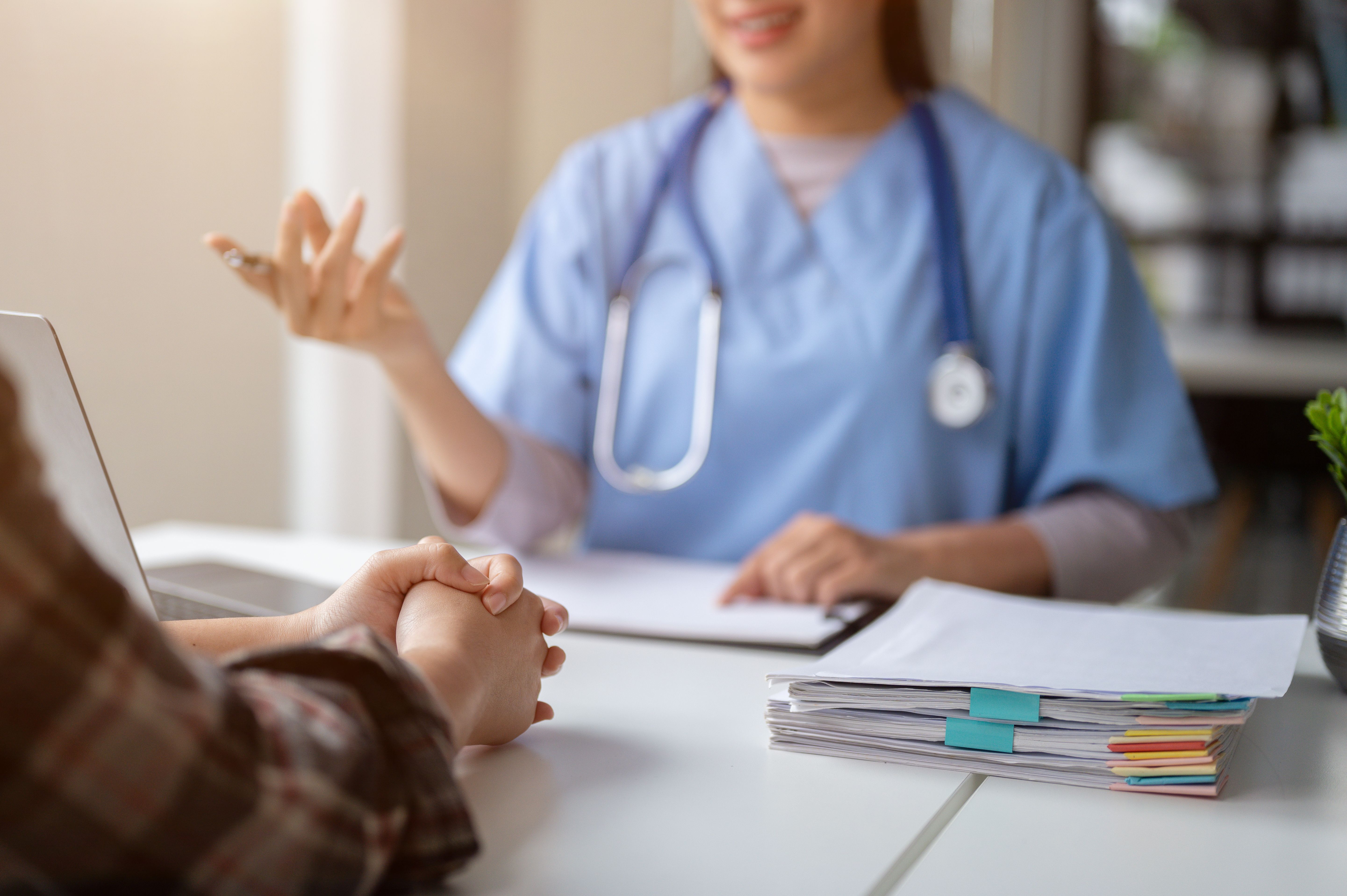 Close-up hand image of a serious patient having a medical consultation with a doctor