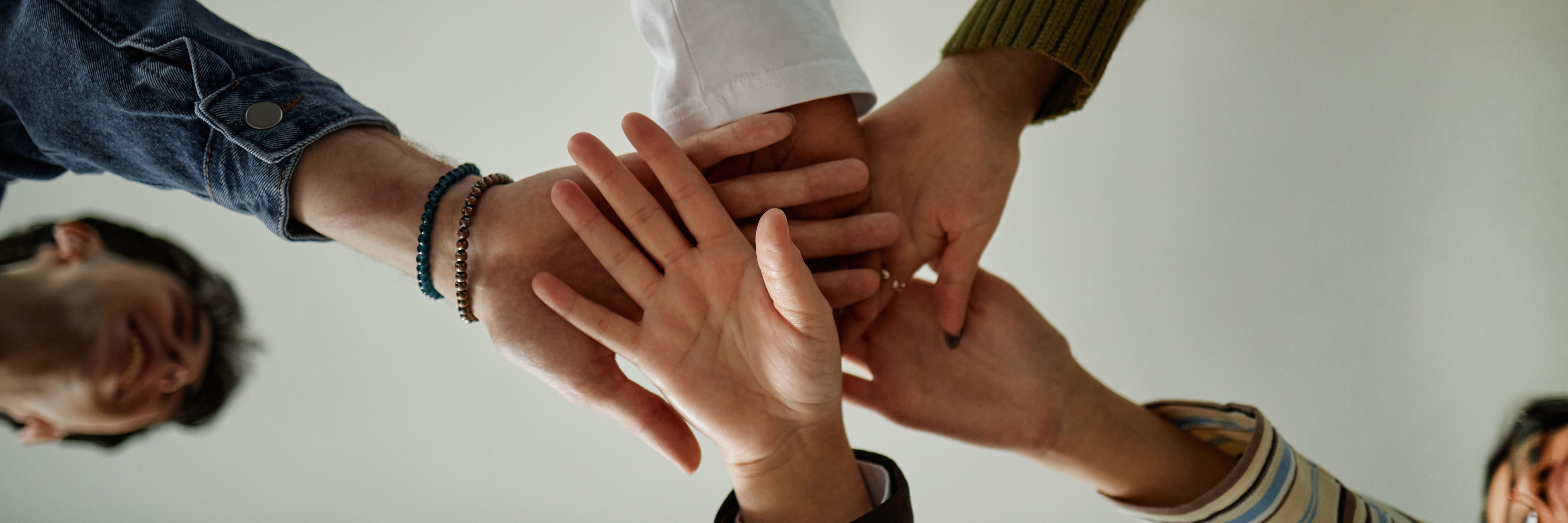 Diverse Teenagers Joining Hands during Counseling Session for Team Building