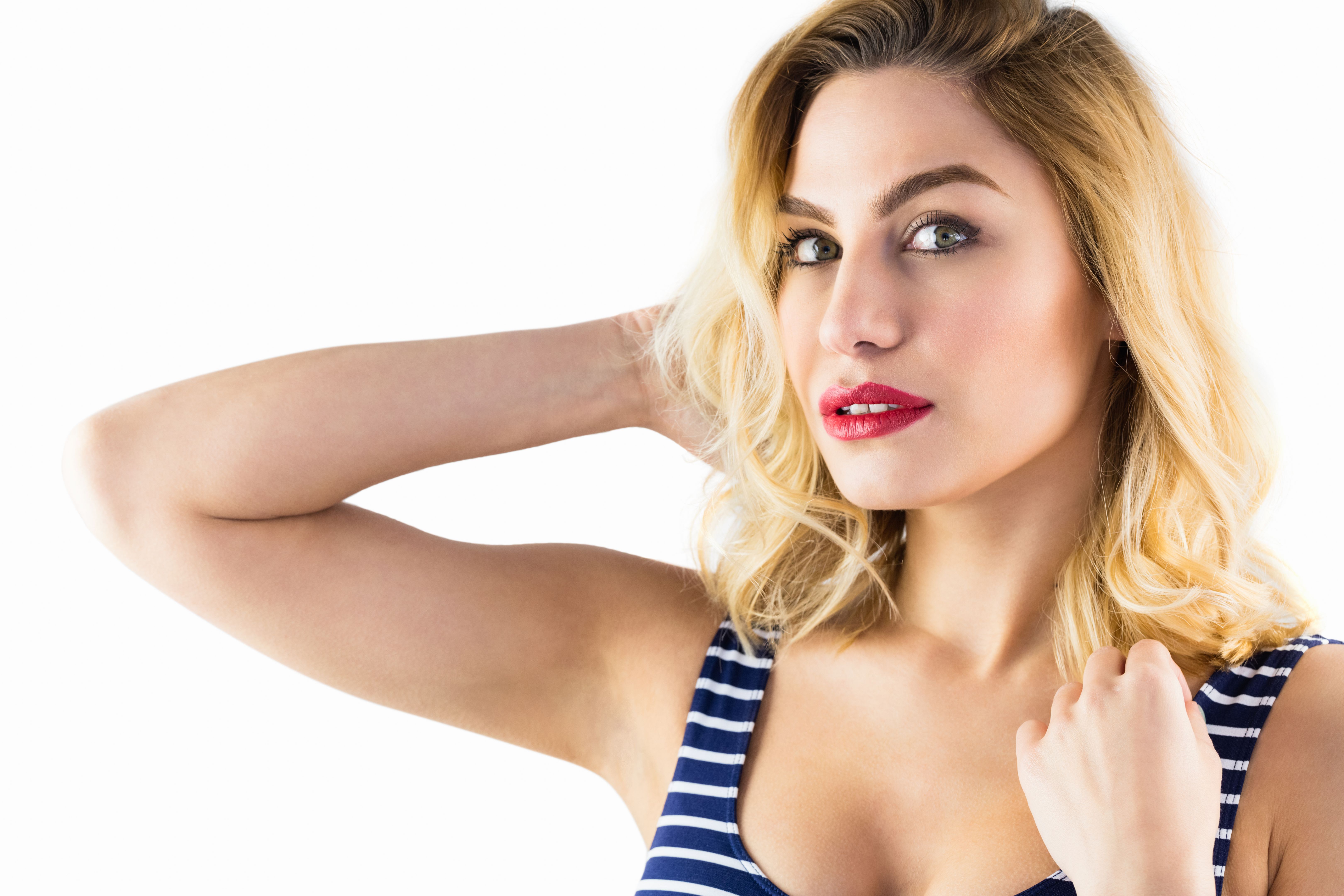 Portrait of beautiful woman posing against white background