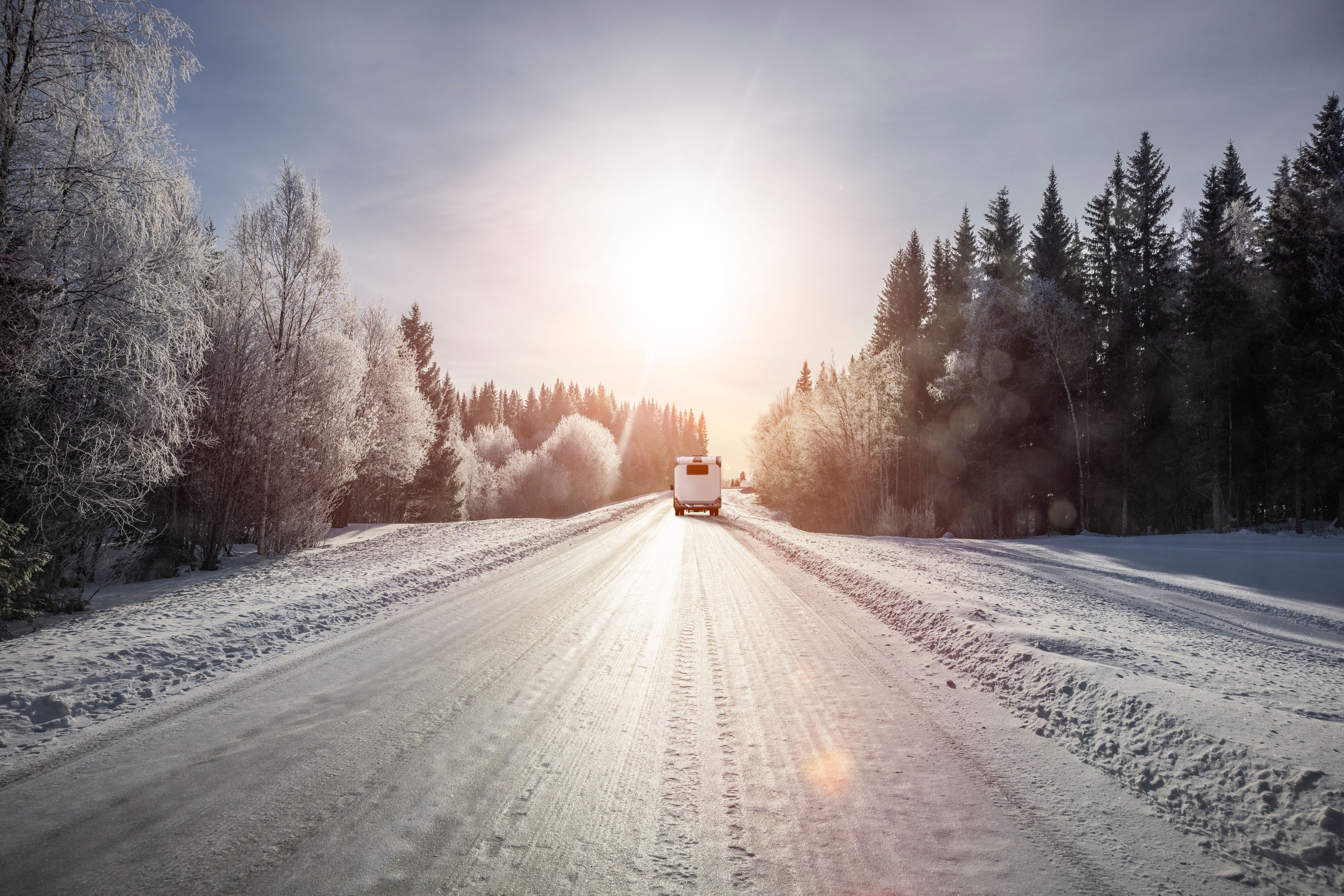 Camper on an icy snow road in winter