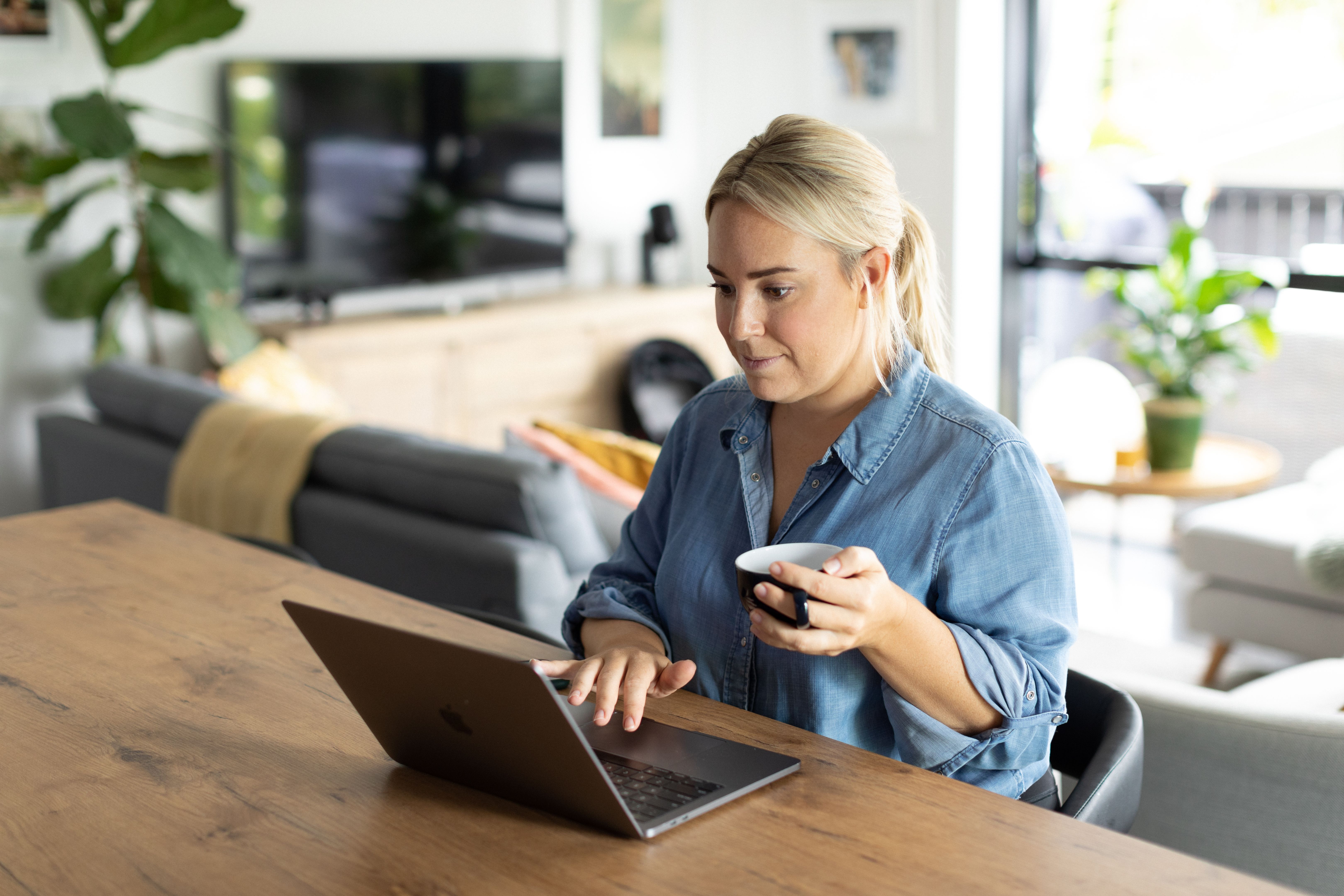 Woman in Kitchen using laptop computer