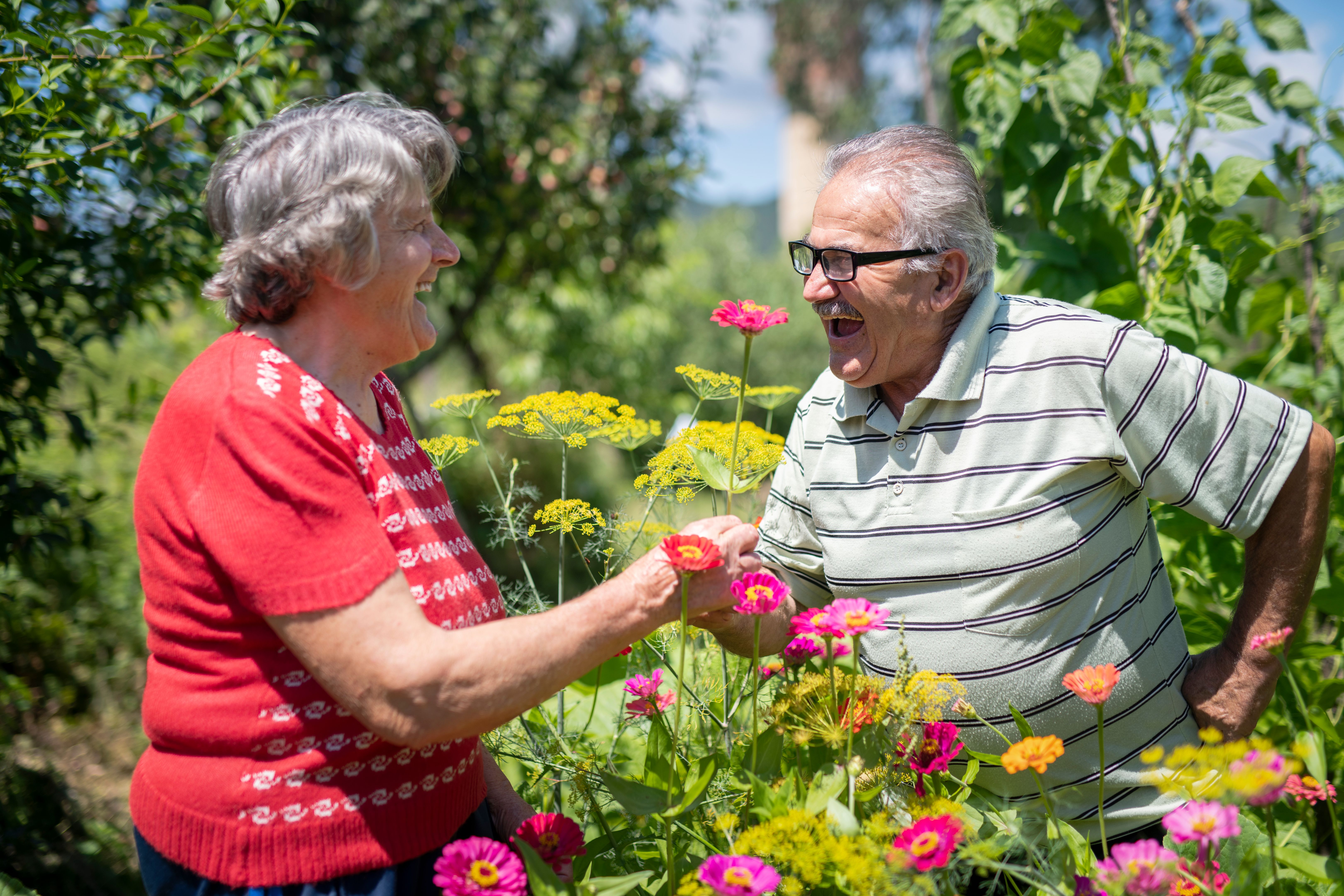 senior enjoying flowers