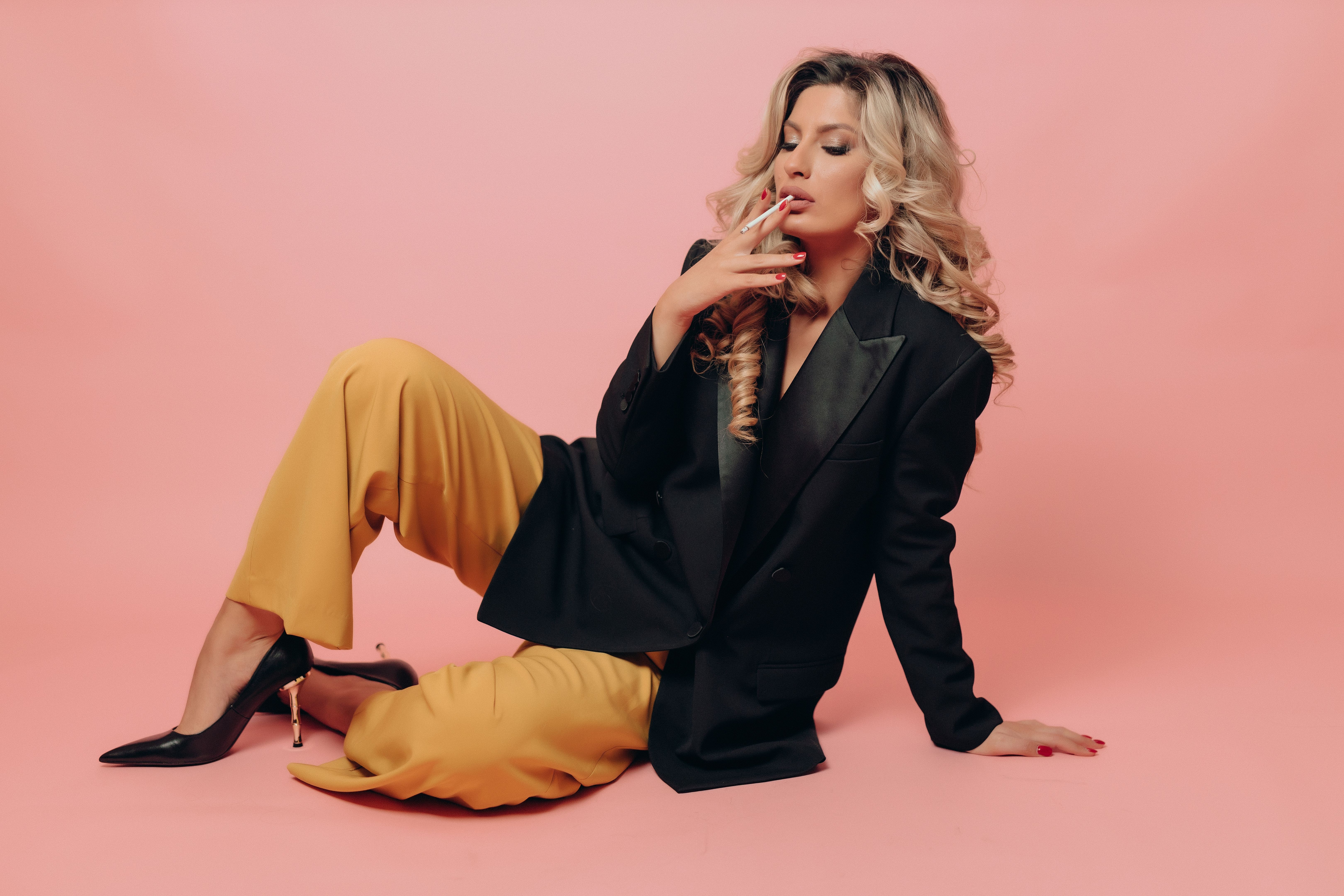 Young fashionable woman smoking a cigarette