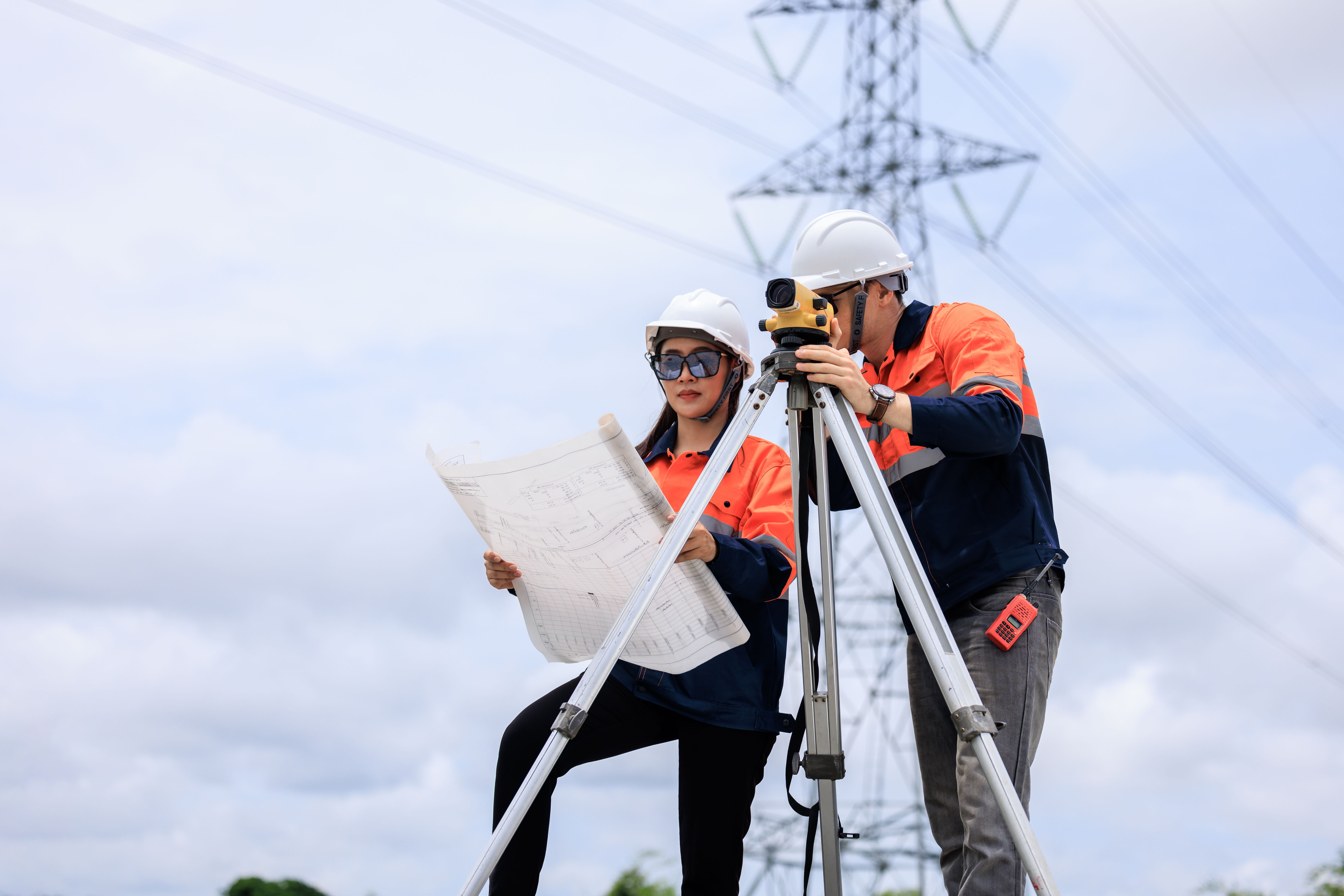 Engineer use theodolite equipment and Blueprint surveying construction worker on Railway site.
