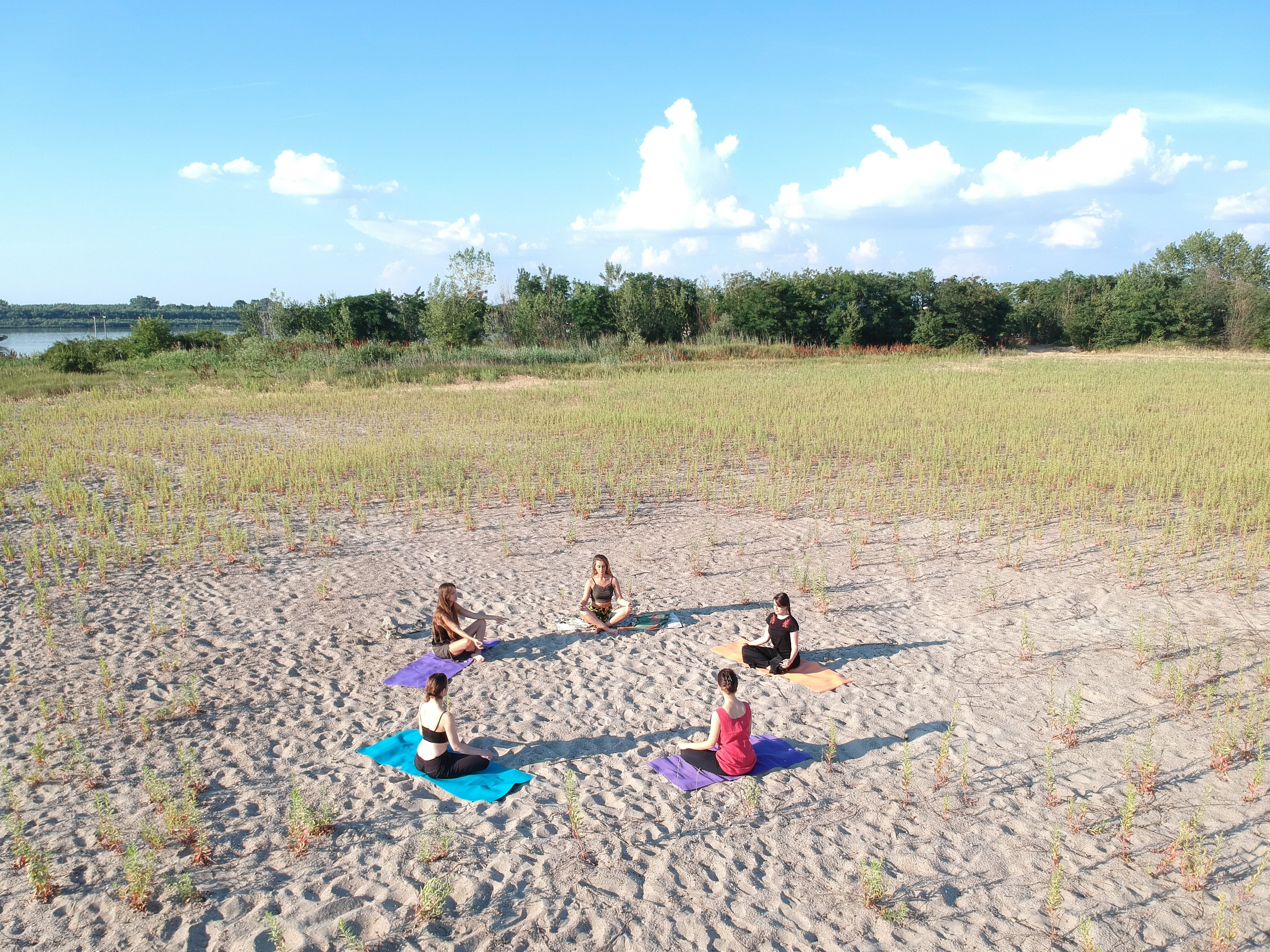 five young women enjoying an outdoor yoga session five young women enjoying an outdoor yoga session