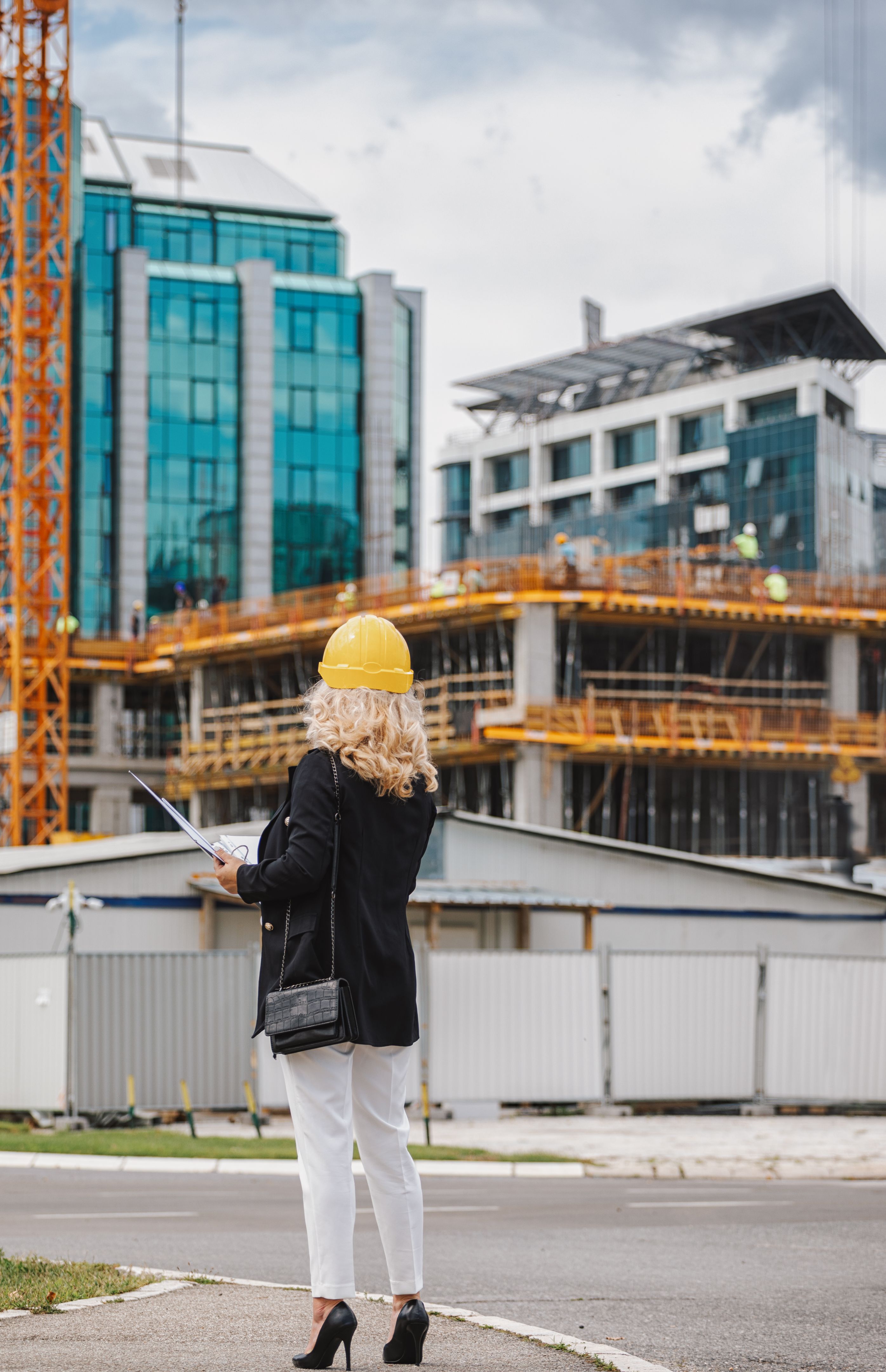 Woman construction manager going to check works on the construction site Woman construction manager going to check works on the construction site