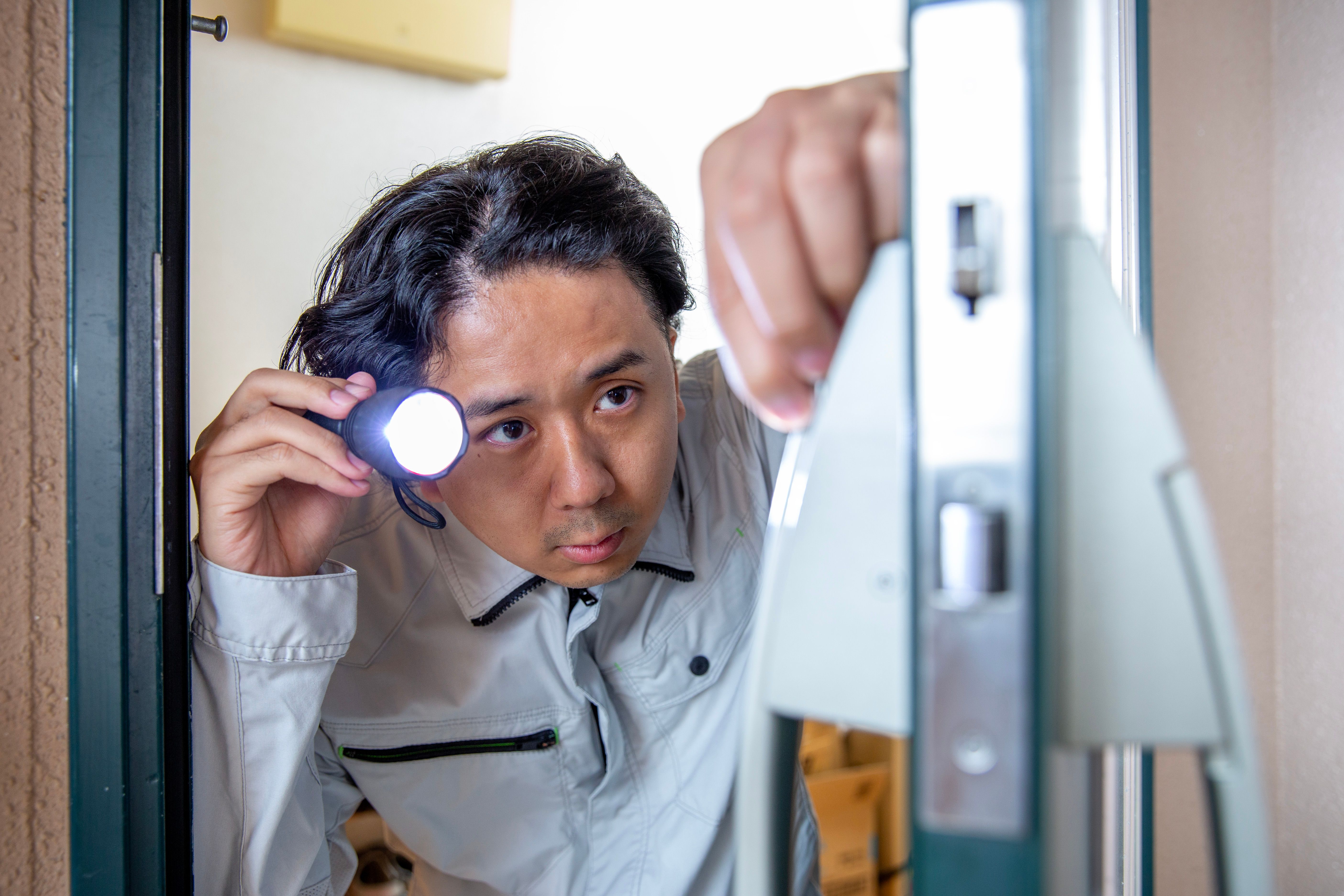 A Japanese man who inspects and repairs entrance locks.