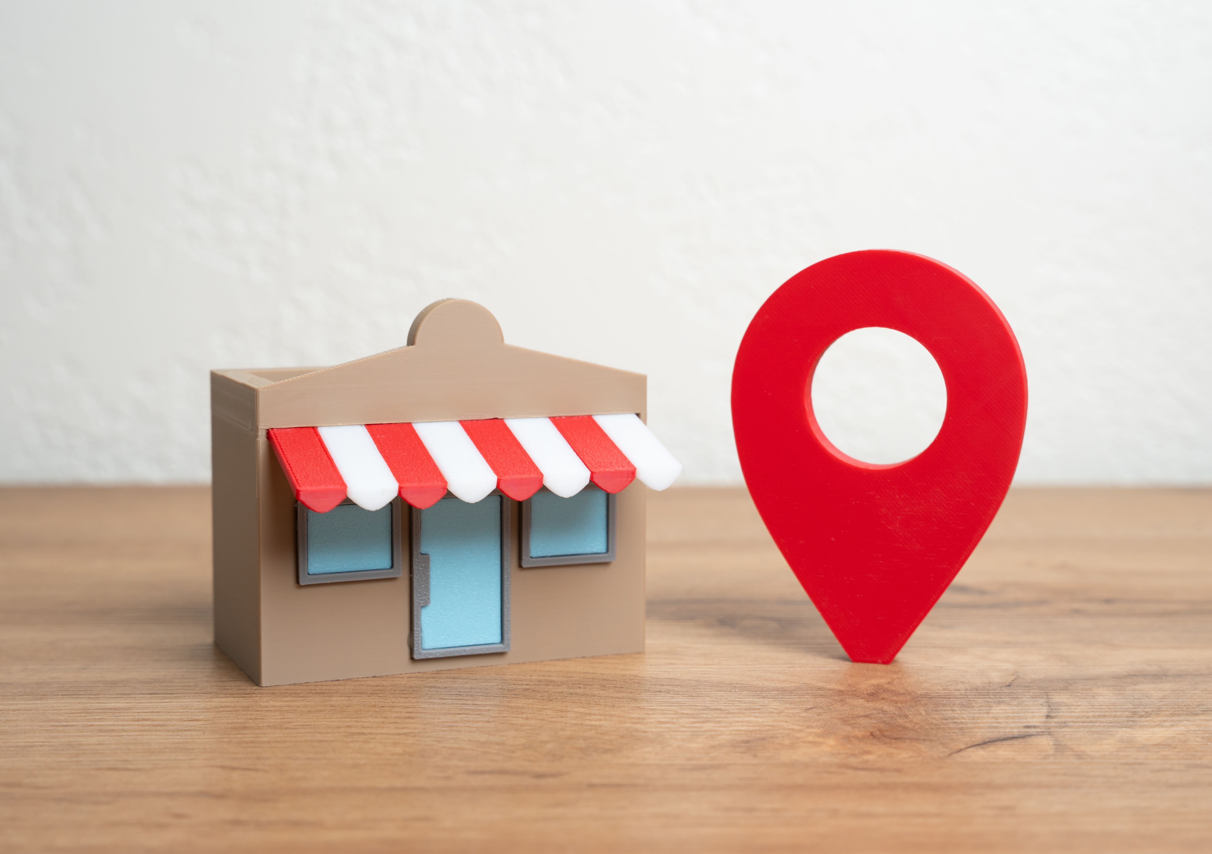 Shop and red geolocation sign. Advertising and presenting your business on maps