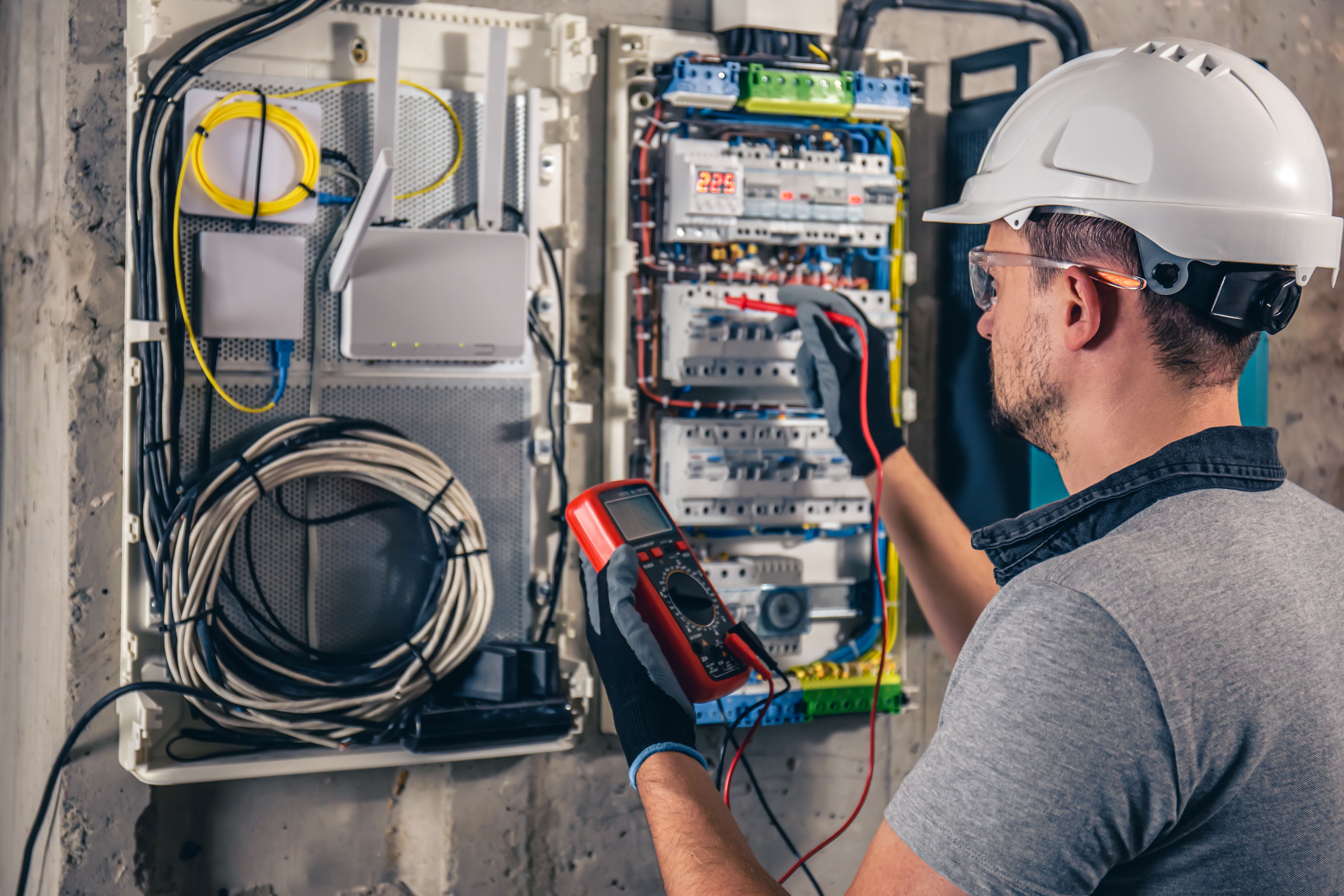 electrician inspecting panel