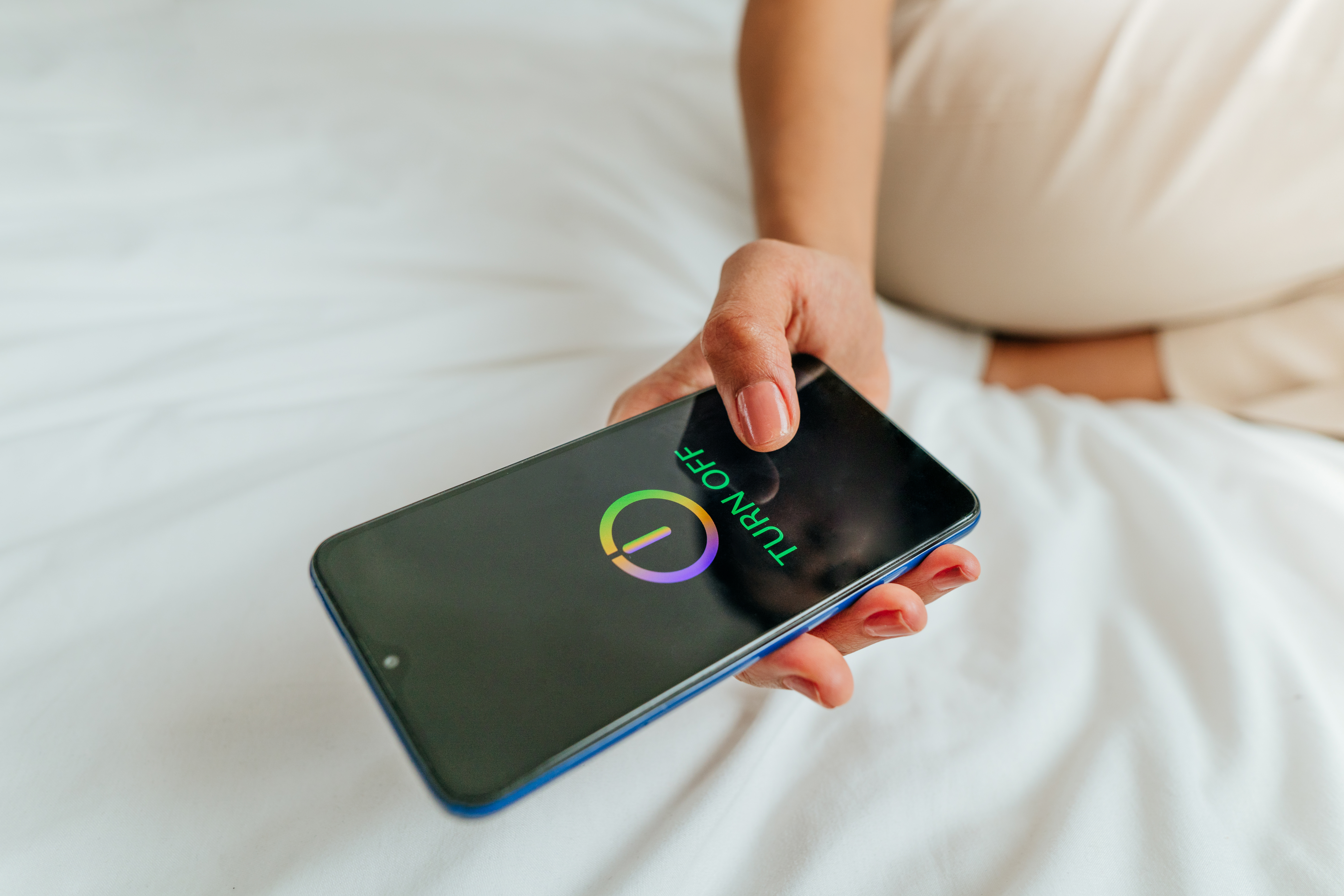 Close up of female hand turning off the smartphone