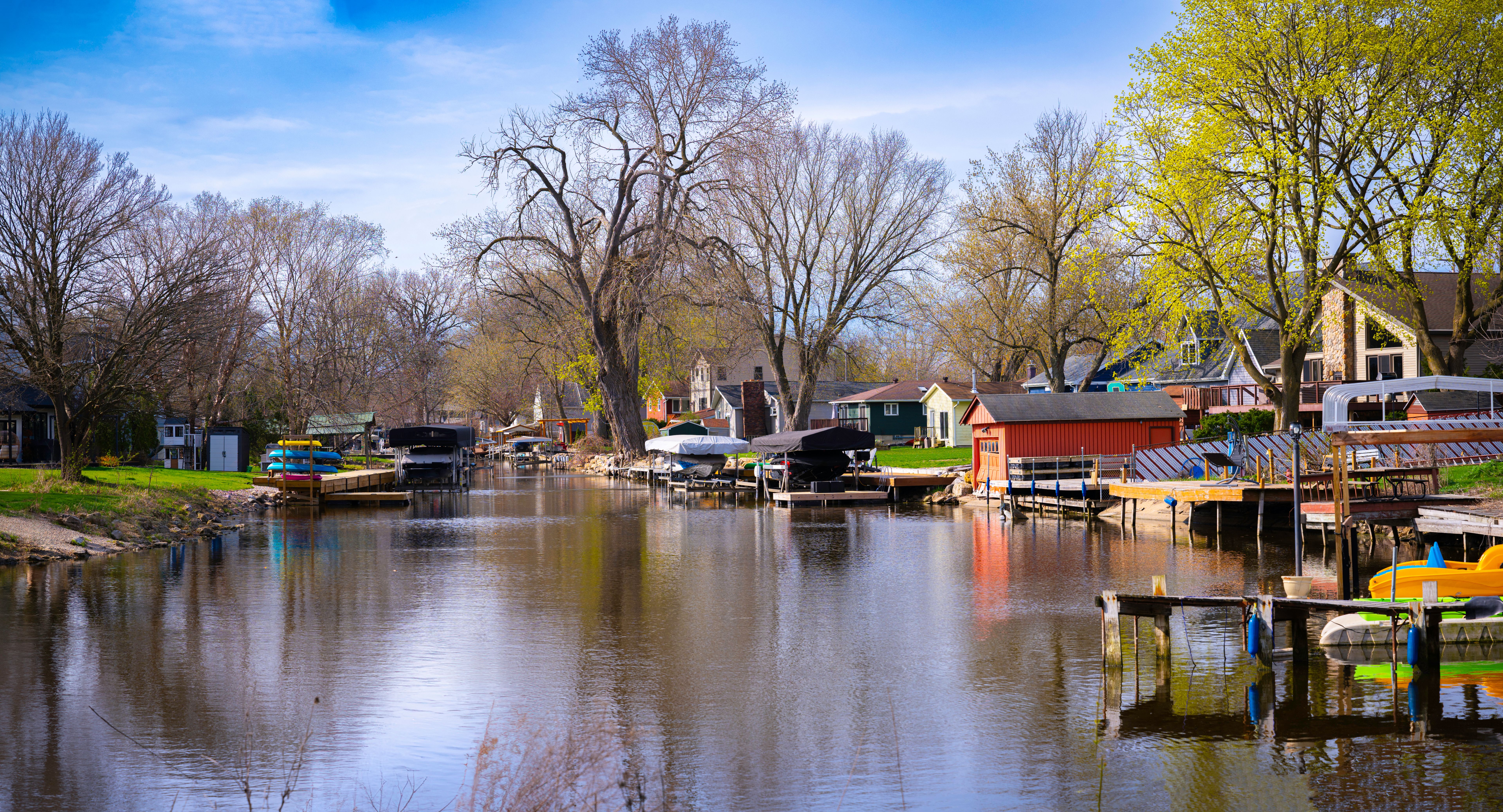 Tranquil fishing village springtime landscape at Wiicawak Bay in Lake Monona, Madison, Wisconsin, USA, moored boats and kayaks getting ready for the season
