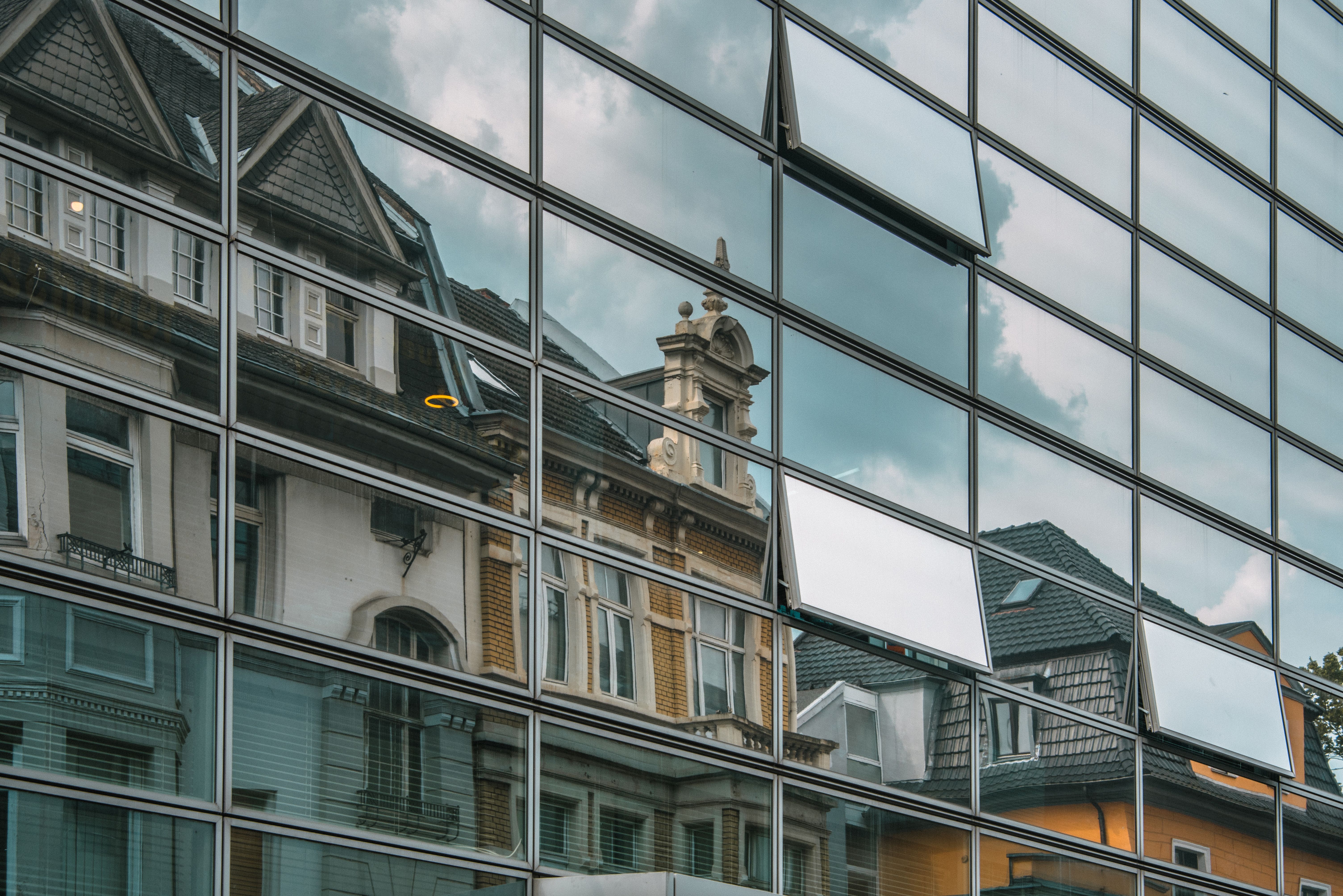 Old buildings reflected on modern facade Old buildings reflected on modern facade