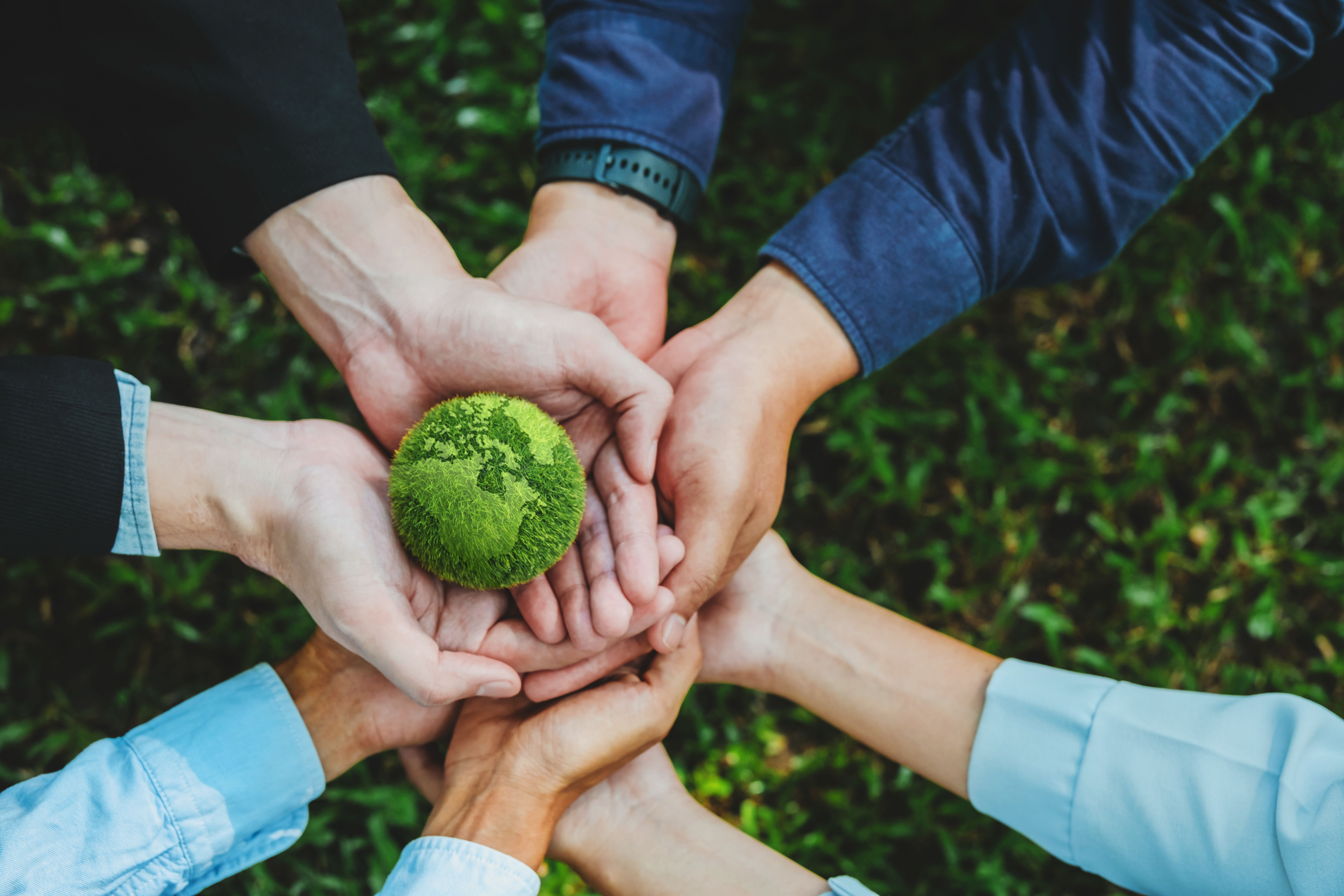 World environment day with global community teamwork and  group of Business people holding earth environmentally together sustainable Save Earth. the Environment World Earth Day concept