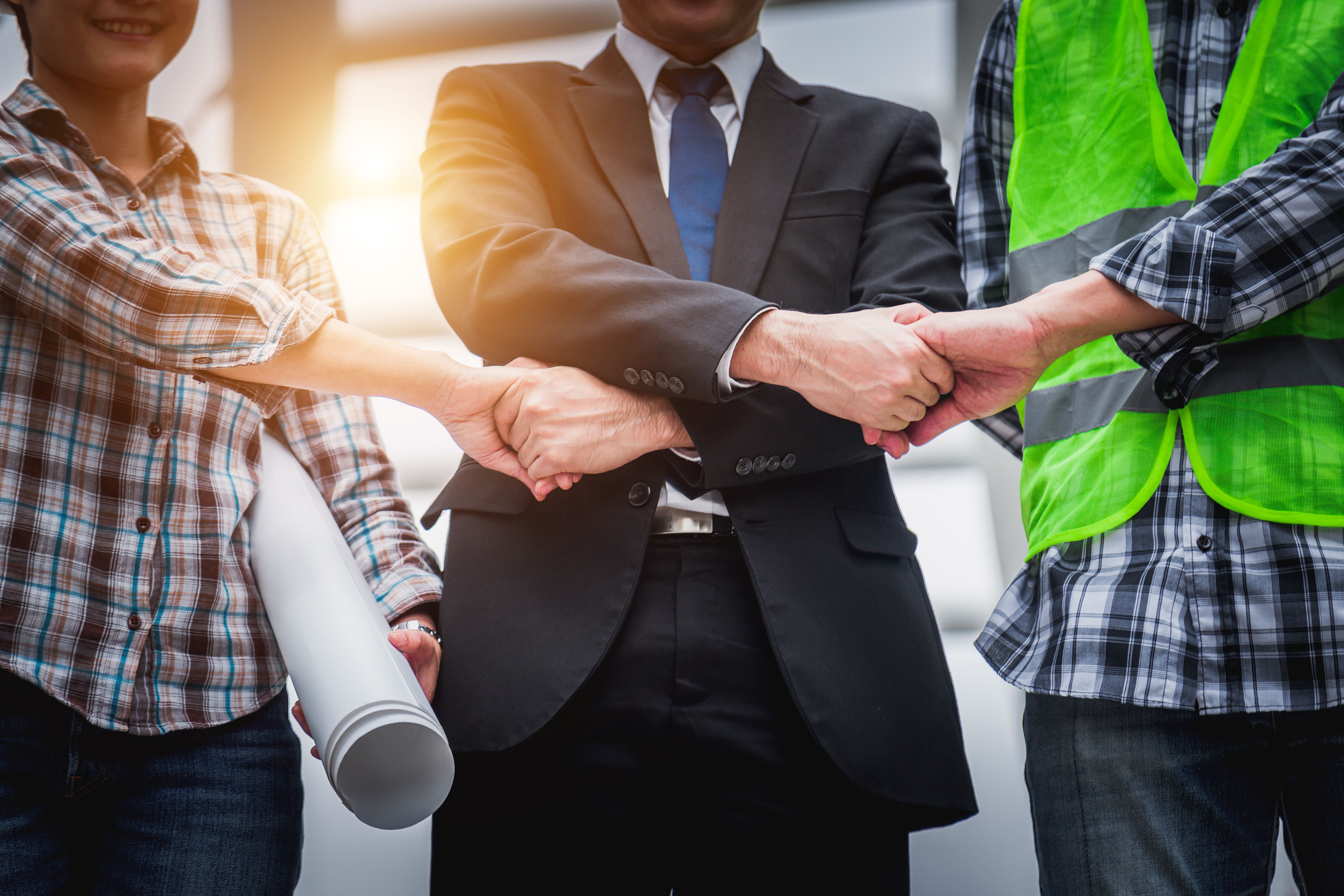 Engineer partnership and togetherness concept. - Business people holding hands together showing teamwork for business success. Engineer partnership and togetherness concept. - Business people holding hands together showing teamwork for business success.
