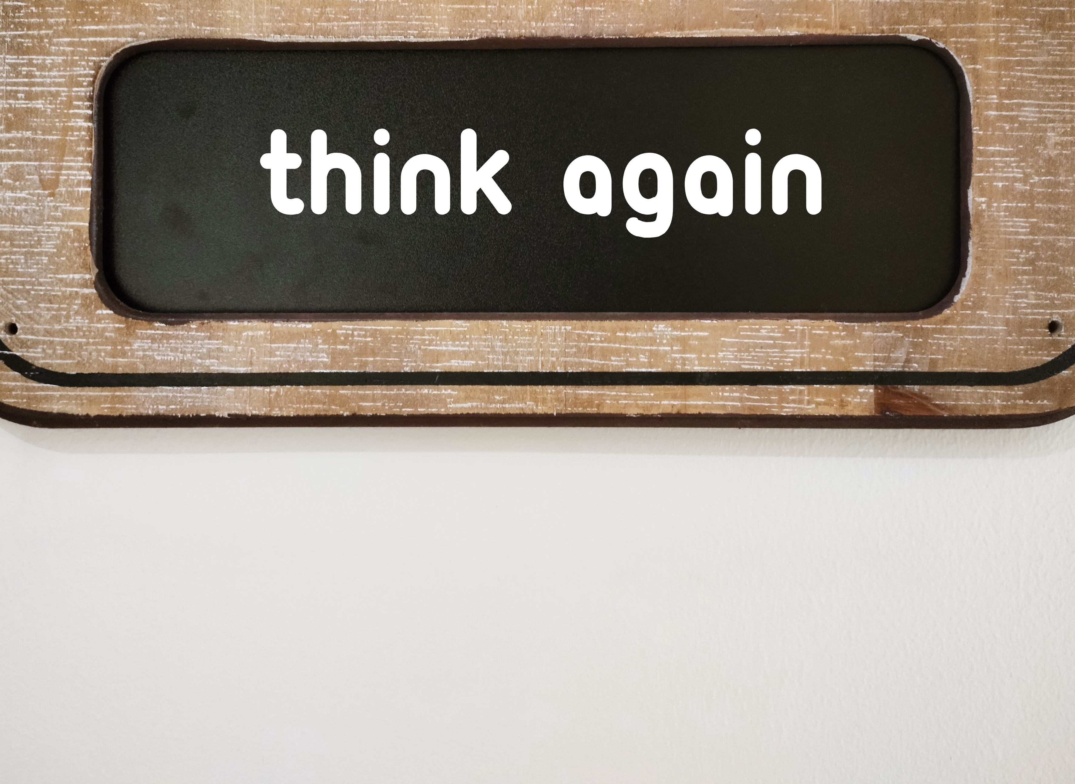 On white copyspace wall, chalkboard written THINK AGAIN, means to think twice before making decision, rethink to lead to excellence at work and wisdom of life On white copyspace wall, chalkboard written THINK AGAIN, means to think twice before making decision, rethink to lead to excellence at work and wisdom of life