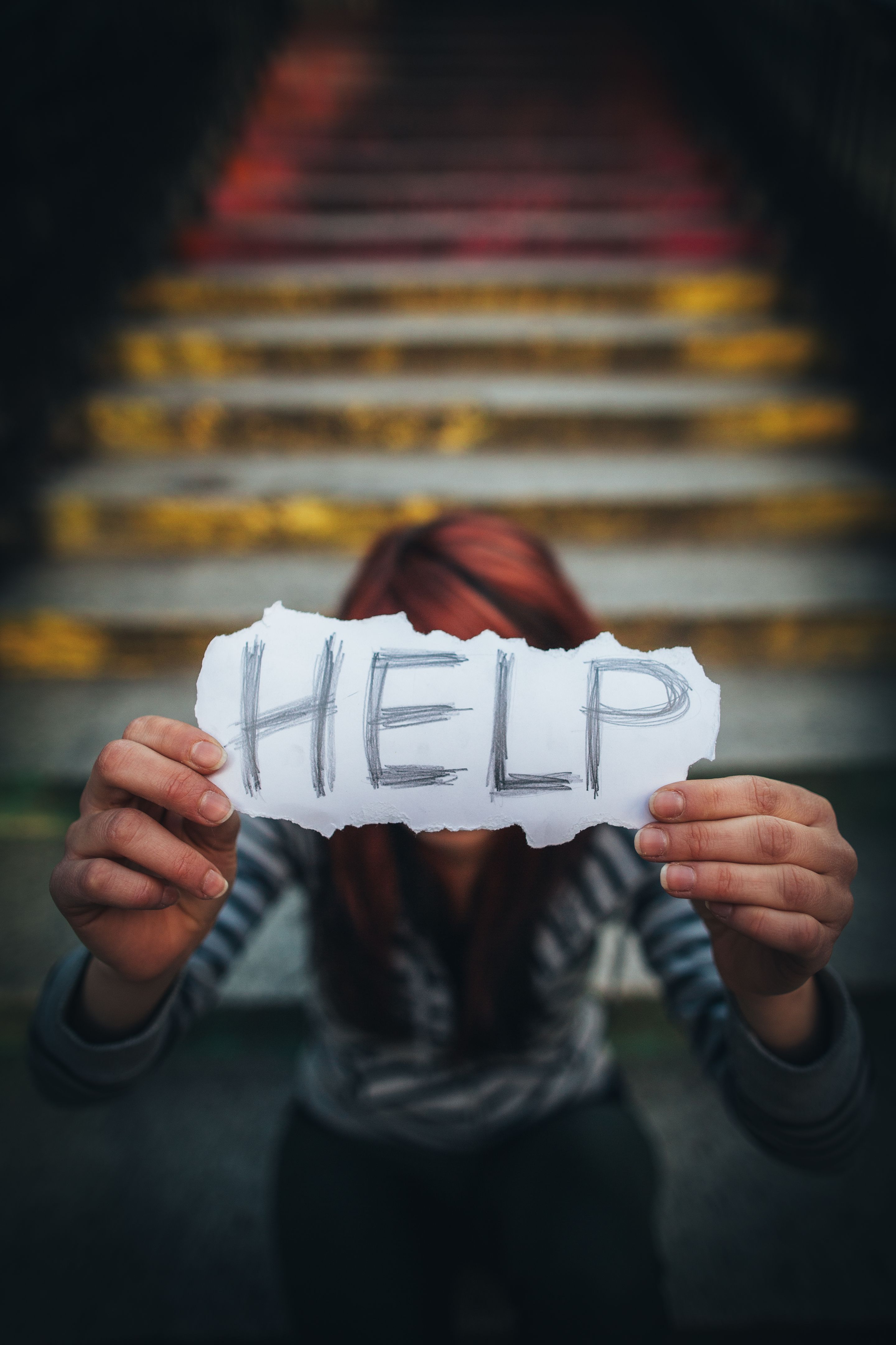 Teen girl holding sign Help