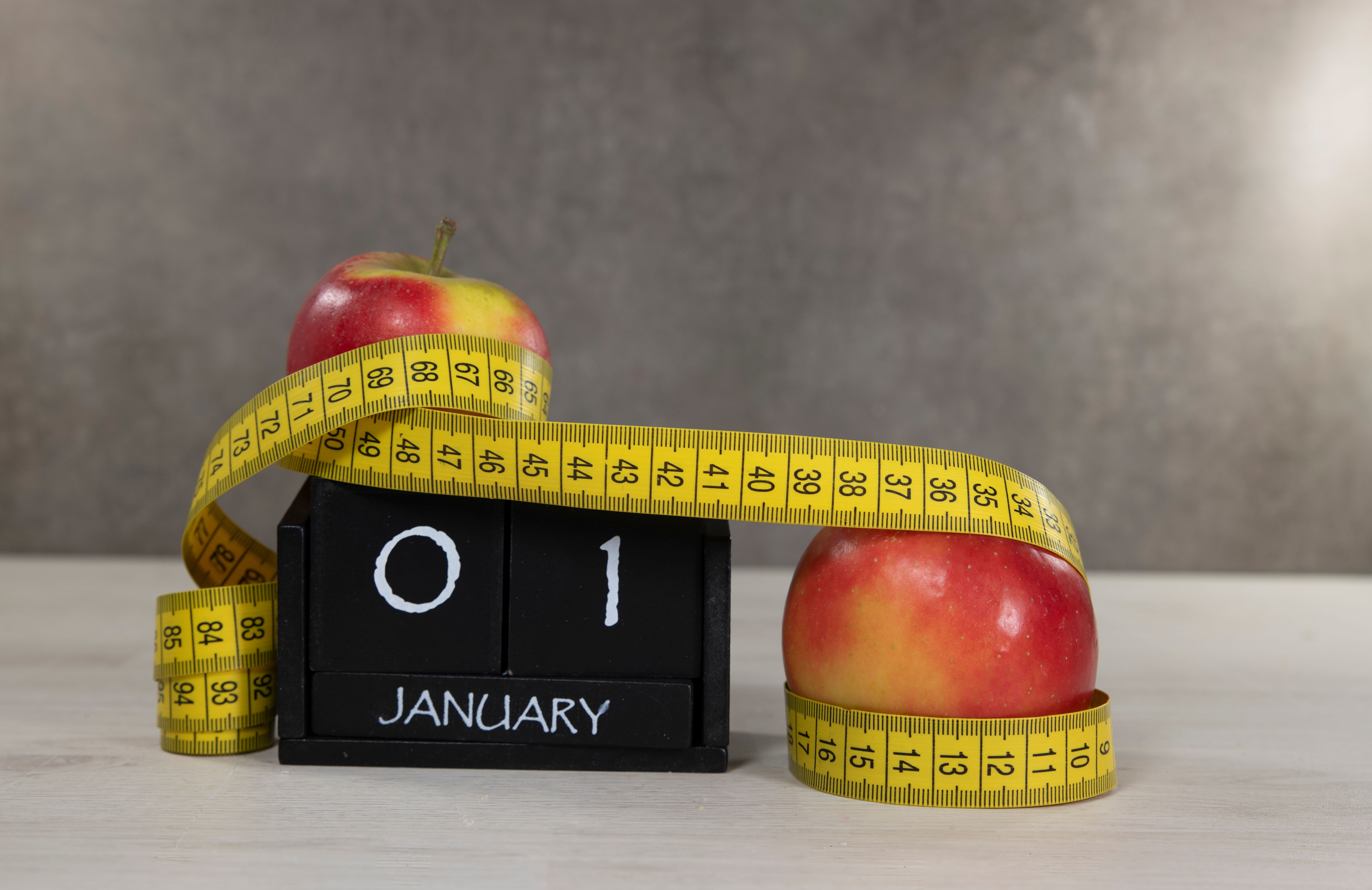 New Year's Resolution Concept With Apples and Measuring Tape New Year's Resolution Concept With Apples and Measuring Tape