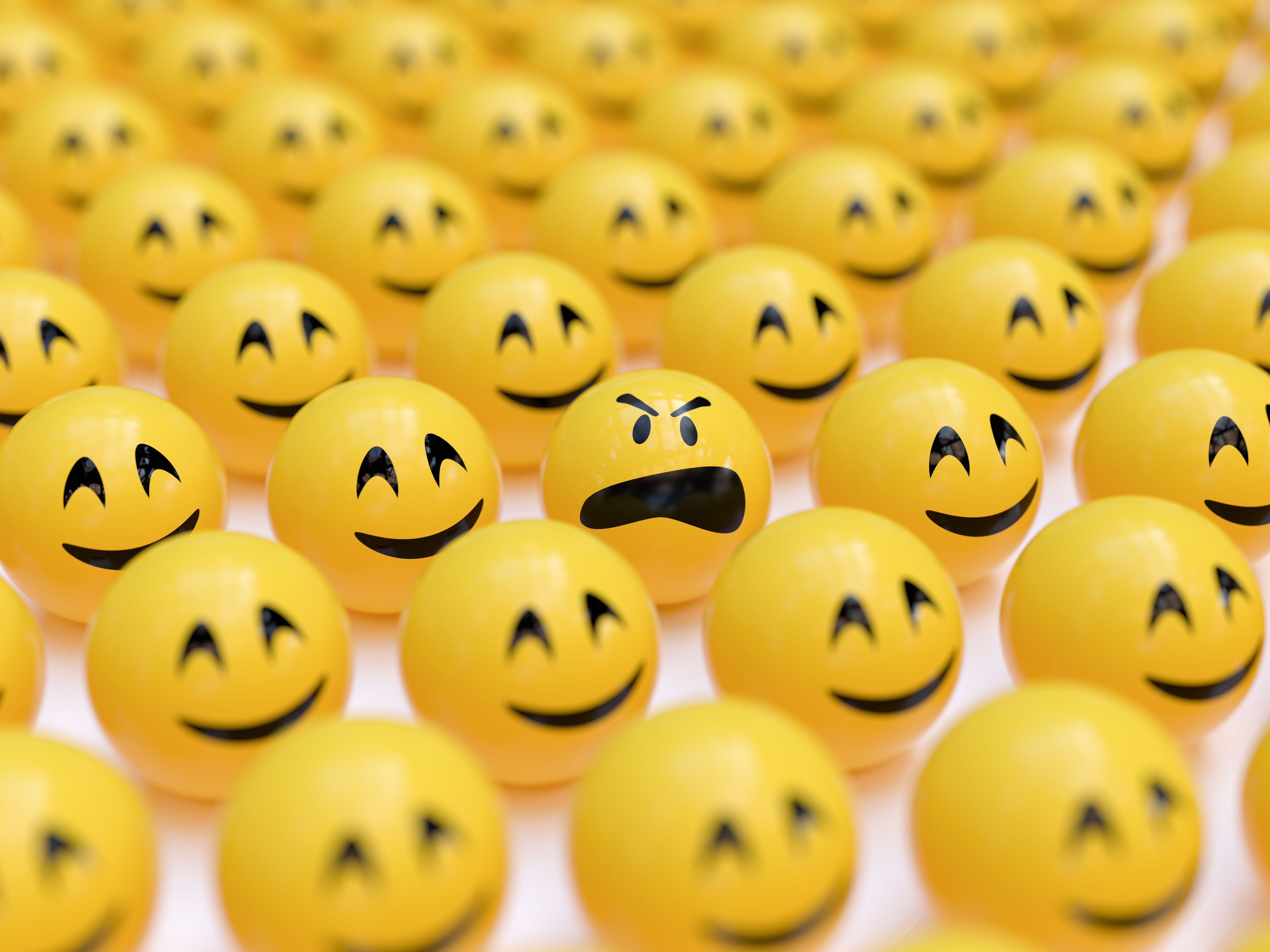 Angry Smiley Between Happy Ones